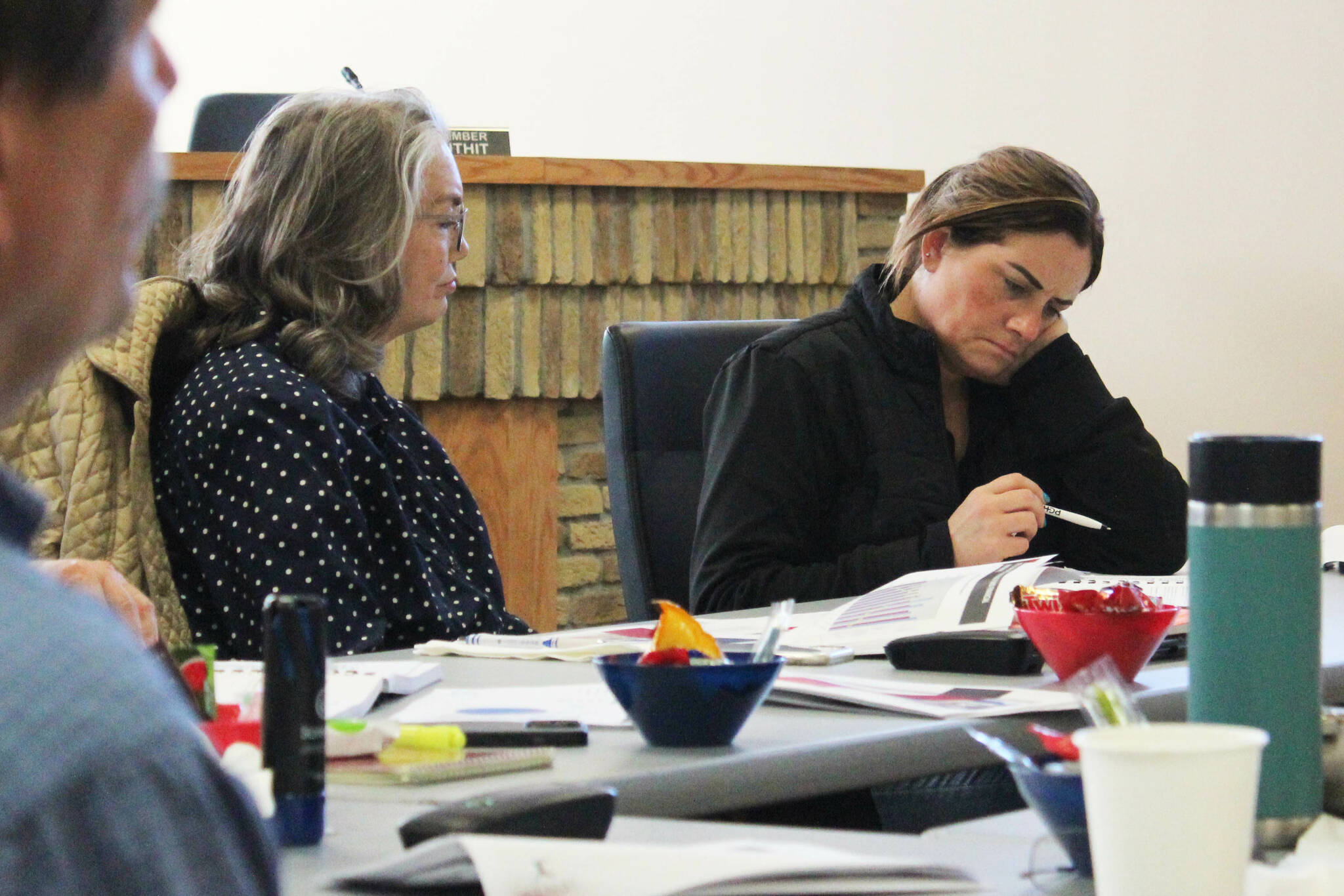 Kenai City Council members Deborah Sounart, left, and Teea Winger review budget documents during a work session on Saturday, April 29, 2023 in Kenai, Alaska. (Ashlyn O’Hara/Peninsula Clarion)