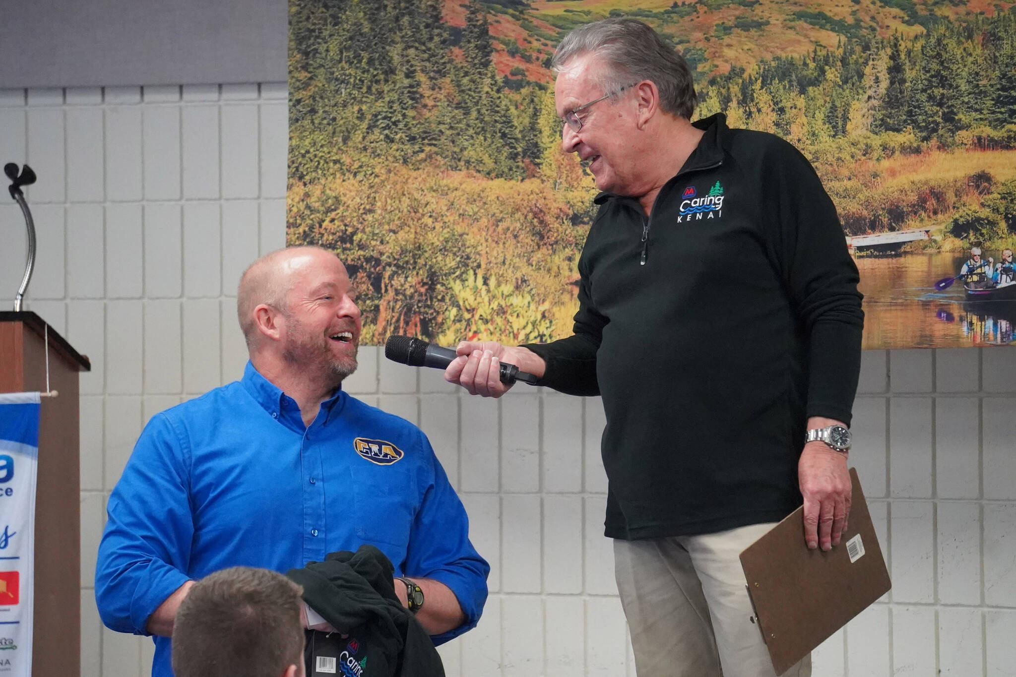 Kenny Leaf, a teacher at Cook Inlet Academy, speaks with Merrill Sikorski at the Caring for the Kenai Awards Celebration held during a Joint Chamber Luncheon on Wednesday, May 3, 2023, at the Soldotna Regional Sports Complex in Soldotna, Alaska. (Jake Dye/Peninsula Clarion)