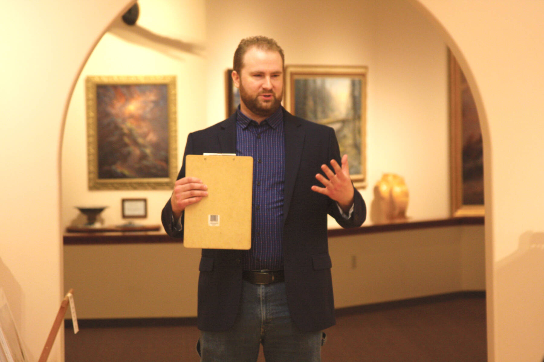 Curator Barnabas Firth welcomes attendees of the invitational gathering on Saturday, April 29, 2023 at the Norman Lowell Art Gallery in Anchor Point, Alaska. Photo by Delcenia Cosman