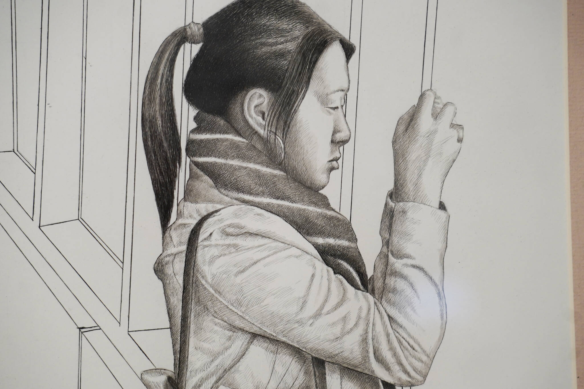 A drawing of a woman and her camera by artist Nathan Perry hangs as part of “Elaborate Expressions” at the Kenai Art Center in Kenai, Alaska on May 3, 2023. (Jake Dye/Peninsula Clarion)