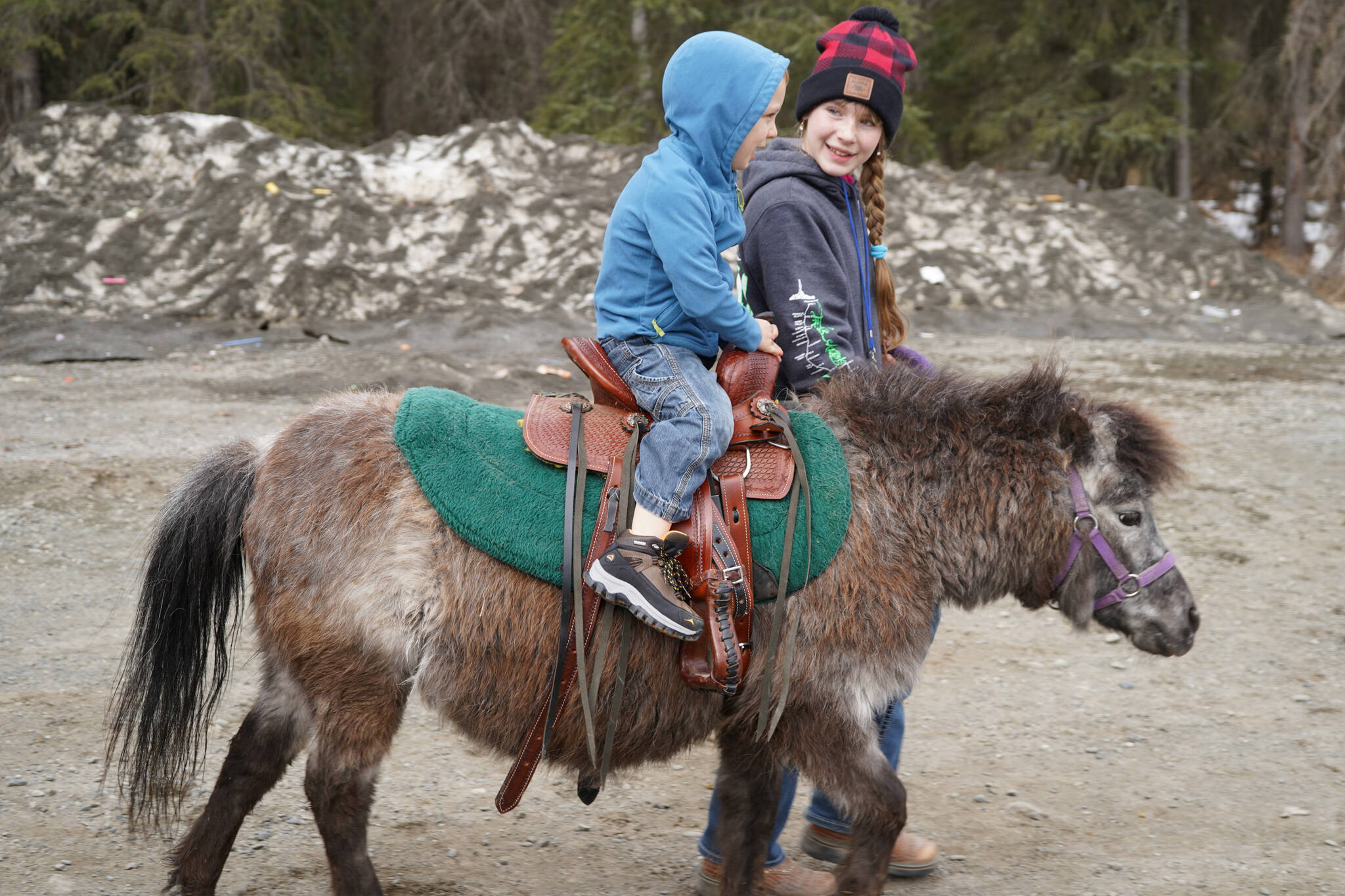 Kilee Barnes leads a boy on a pony at the Kenai Peninsula Sport, Rec & Trade Show on Saturday, May 6, 2023, at the Soldotna Regional Sports Complex in Soldotna, Alaska. (Jake Dye/Peninsula Clarion)