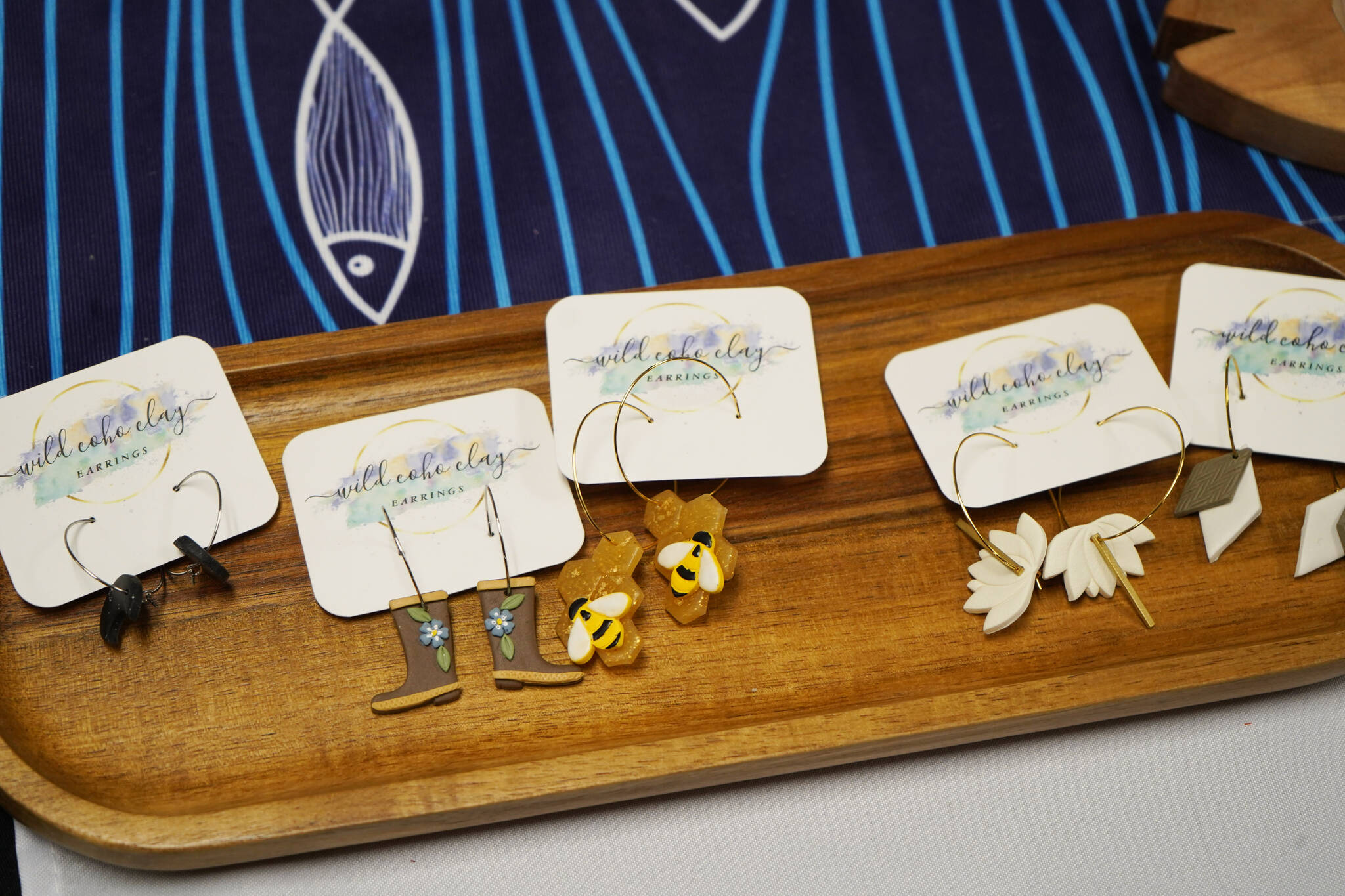 Ceramic earrings made by Michelle Carmichael are displayed at the Kenai Peninsula Sport, Rec & Trade Show on Saturday, May 6, 2023, at the Soldotna Regional Sports Complex in Soldotna, Alaska. (Jake Dye/Peninsula Clarion)