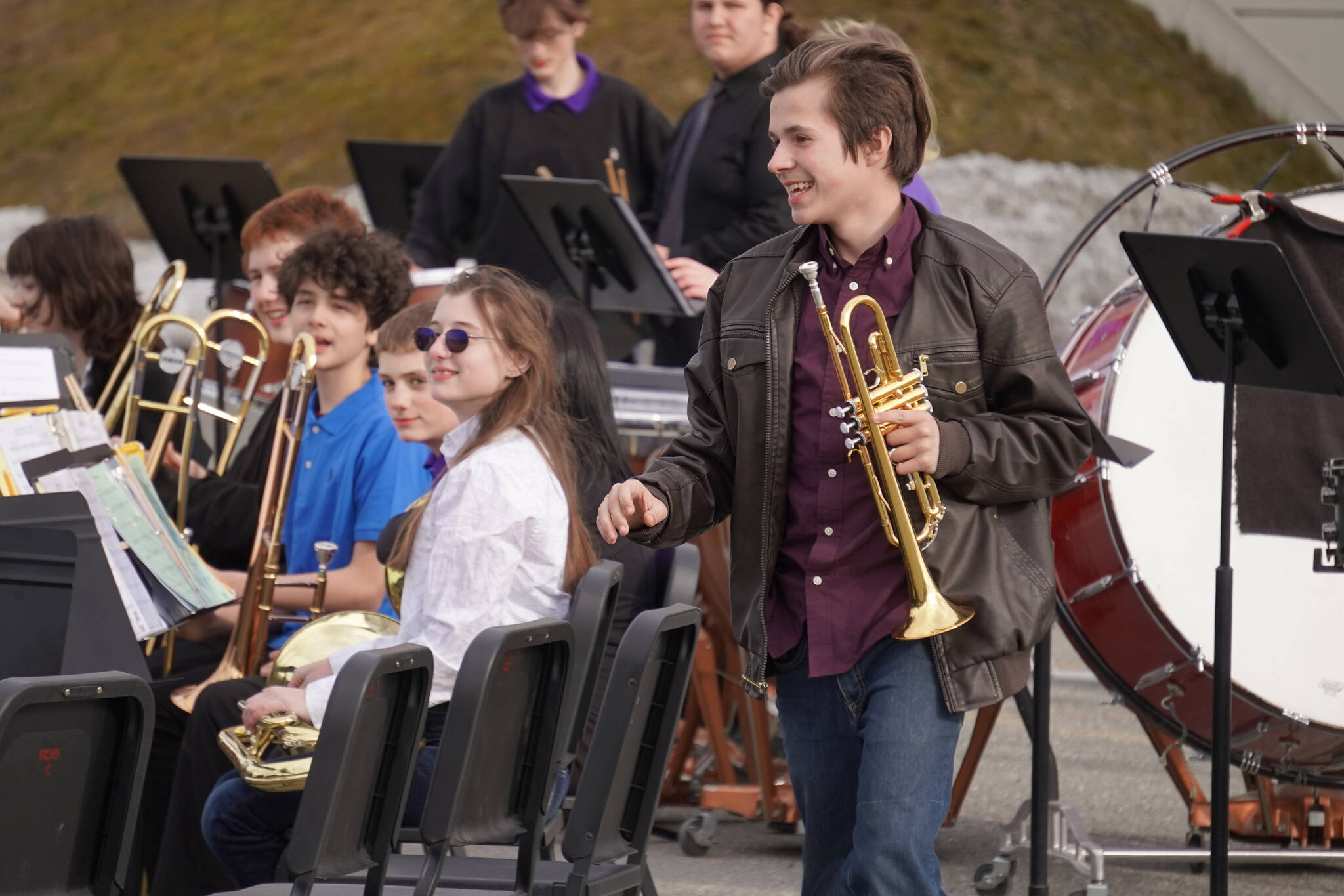 A Kenai Middle School Concert Band trumpet player walks up to receive an award during Pops in the Parking Lot at Kenai Central High School in Kenai, Alaska, on Thursday, May 4, 2023. (Jake Dye/Peninsula Clarion)