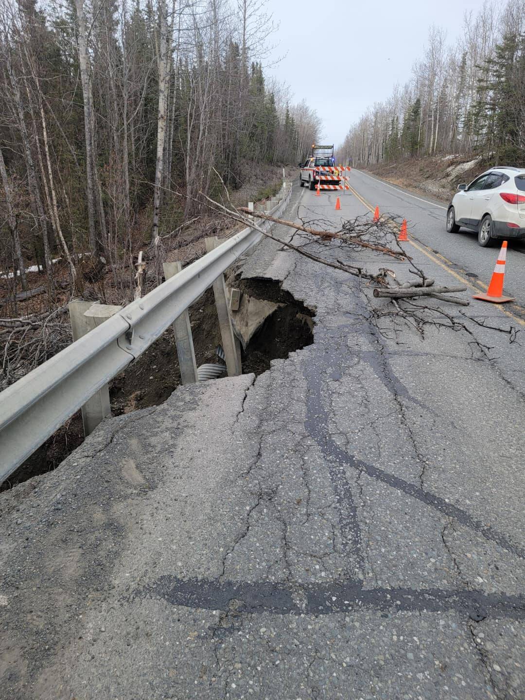 Trees surround broken pavement on Funny River Road on Friday, May 5, 2023, near Soldotna, Alaska. (Photo via Kenai Peninsula Borough Office of Emergency Management)
