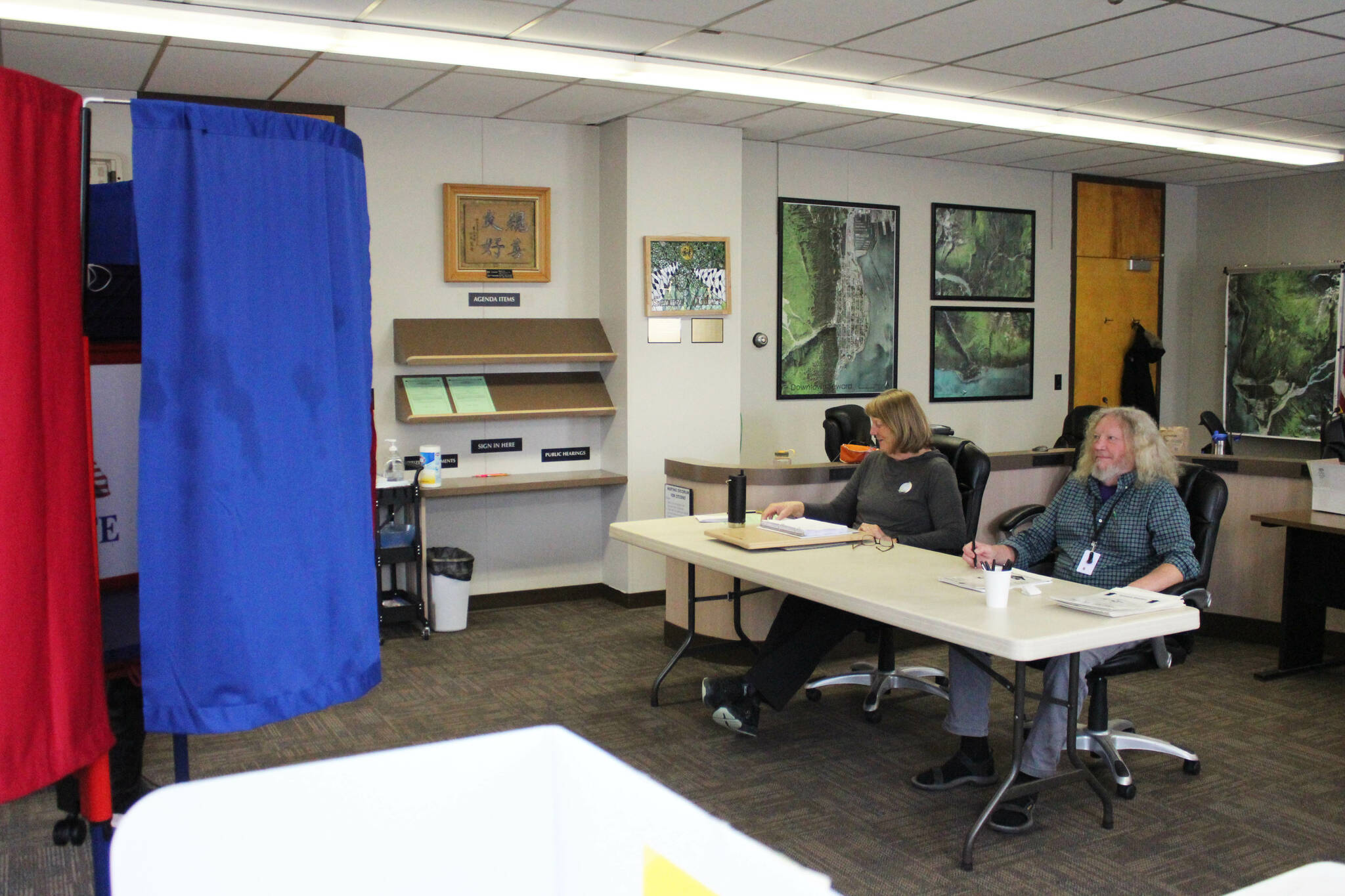 Poll workers Patricia Linville, left,, and Mark Kansteiner prepare to assist voters in Seward’s special election on Tuesday, May 2, 2023, in Seward, Alaska. (Ashlyn O’Hara/Peninsula Clarion)