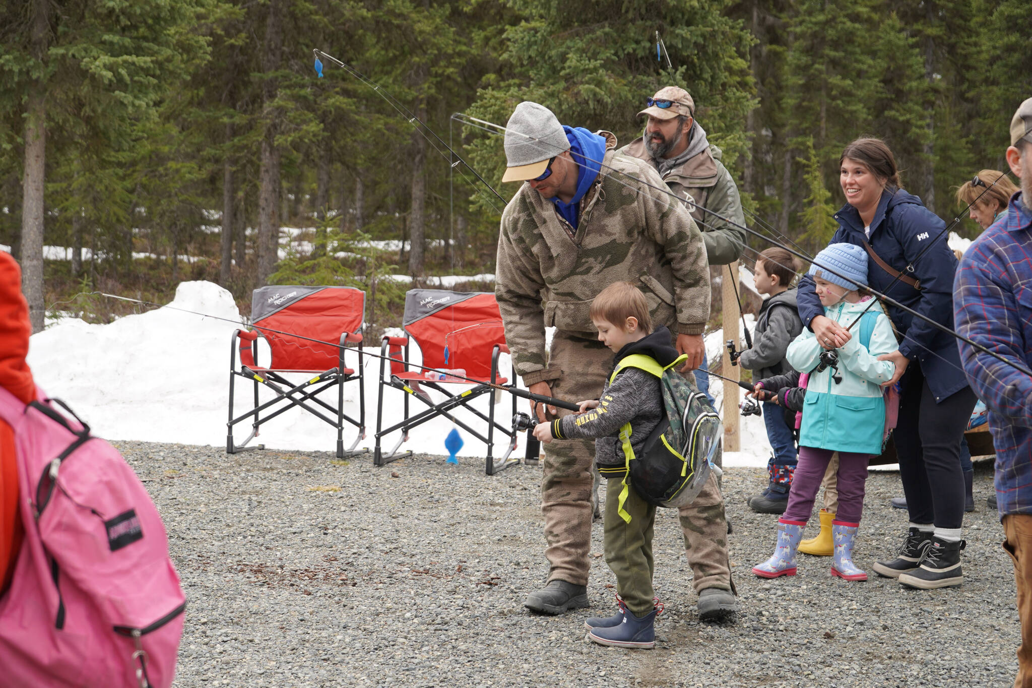 Members of the Kenai River Professional Guide Association teach elementary students to cast a fly rod during Salmon Celebration on Wednesday, May 10, 2023, at Johnson Lake in Kasilof, Alaska. (Jake Dye/Peninsula Clarion)