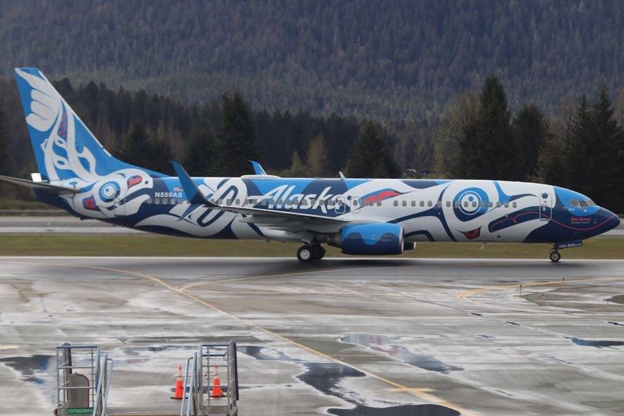 Xáat Kwáani sits on the wet tarmac at Juneau International Airport after landing Friday morning. (Jonson Kuhn / Juneau Empire)