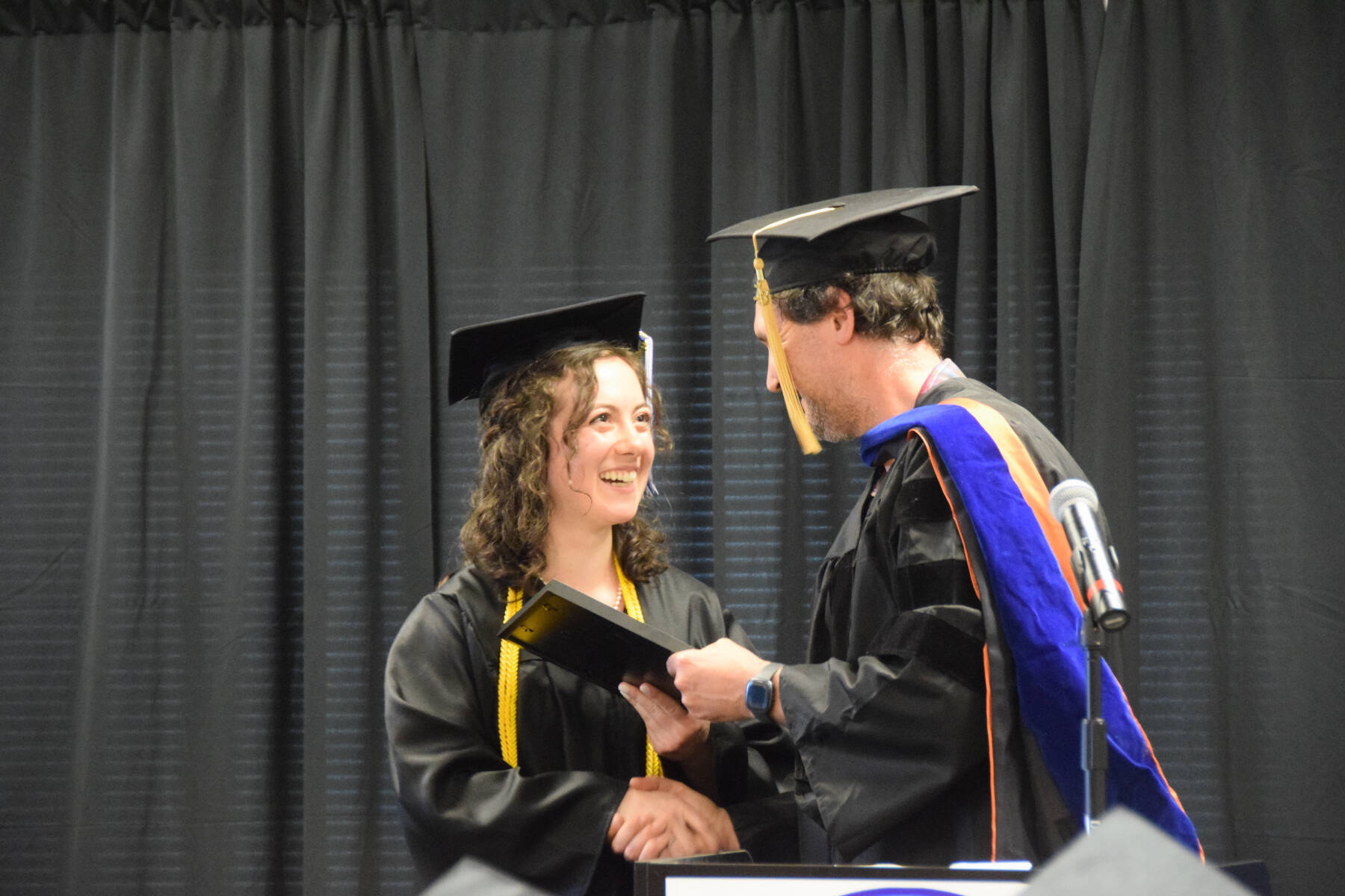 Kachemak Bay Campus Assistant Professor of Mathematics Dr. Jeff Johnson (right) presents the KBC Faculty Choice Award to valedictorian Elizabeth Rozeboom (left) during the 2023 KBC Commencement on Wednesday, May 10, 2023, in Homer, Alaska. (Photo by Delcenia Cosman/Homer News)