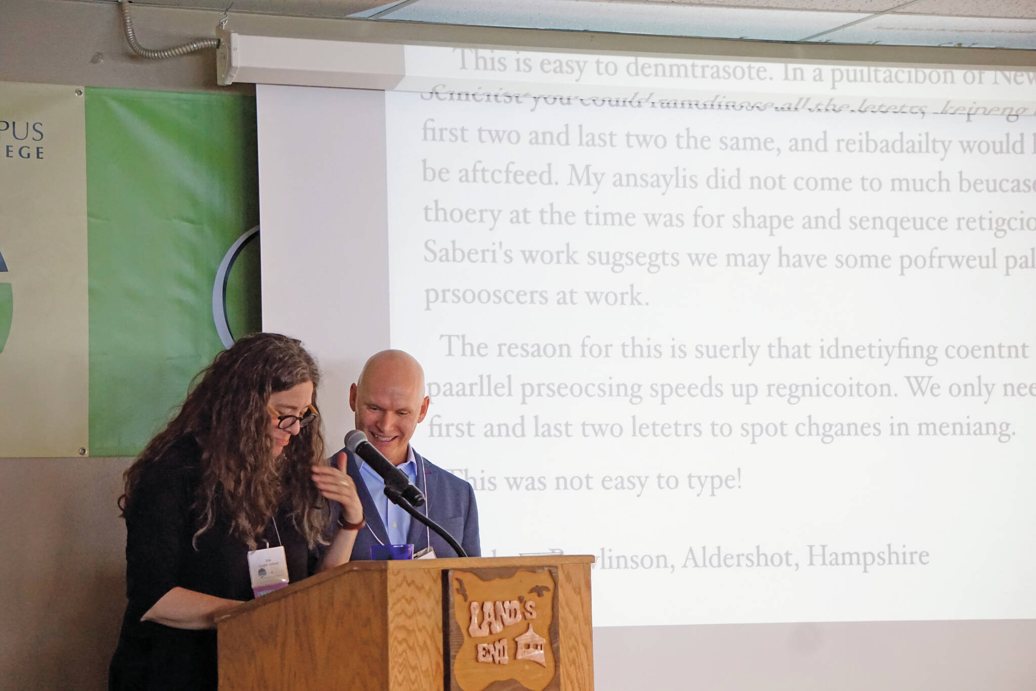 Homer poet and Kachemak Bay Writers’ Conference faculty member Erin Coughlin Hollowell, left, reads a passage that shows words can be understood even when the letters are garbled as 2018 keynote speaker Anthony Doerr watches. Doerr delivered the opening address at the start of the annual conference on June 5, 2018, at Land’s End Resort in Homer, Alaska. (Photo by Michael Armstrong/Homer News)
