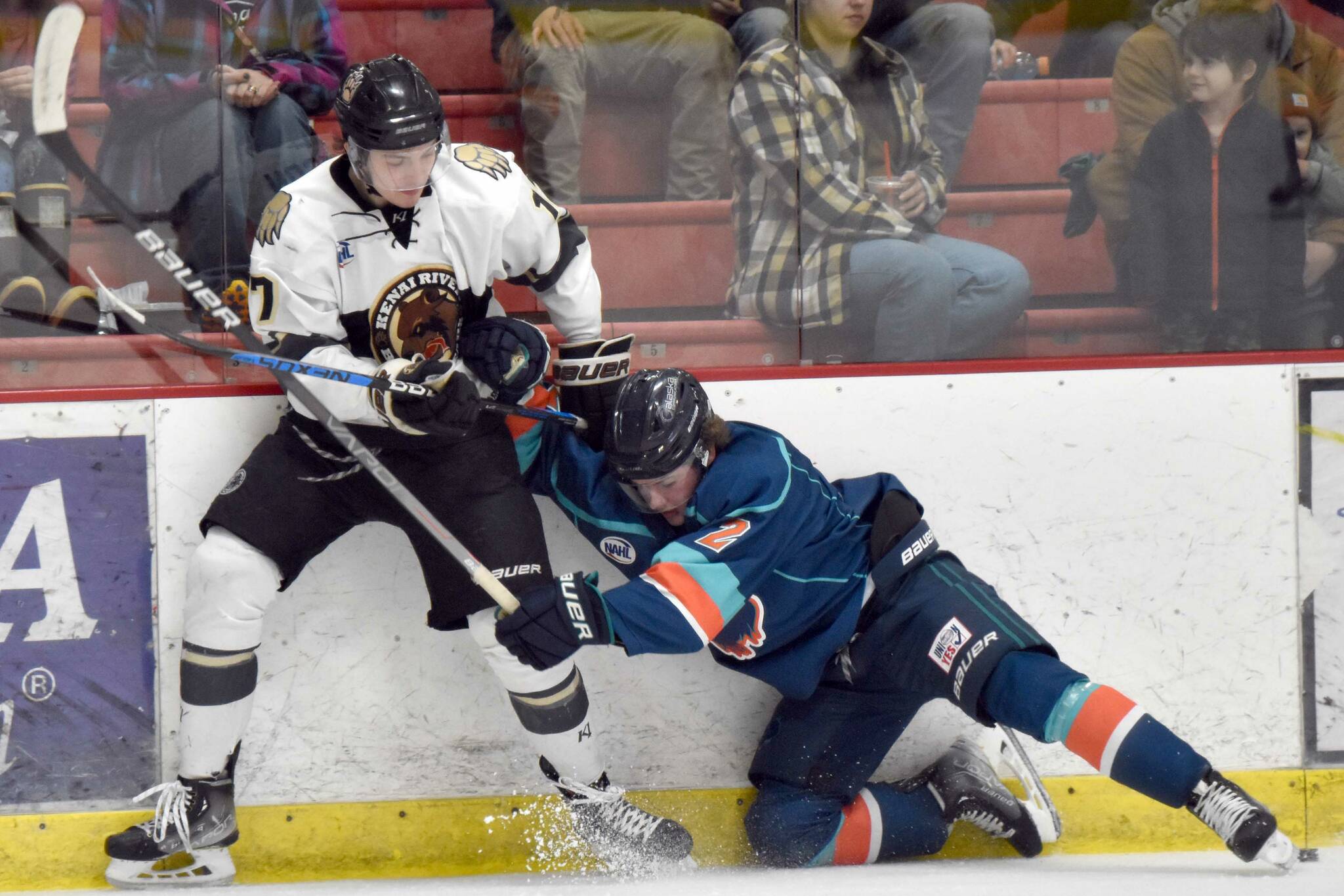 Kenai River Brown Bears forward Owen Hanson and Anchorage Wolverines defenseman Trent Powell battle for the puck Saturday, Dec. 3, 2022, at the Soldotna Regional Sports Complex in Soldotna, Alaska. (Photo by Jeff Helminiak/Peninsula Clarion)