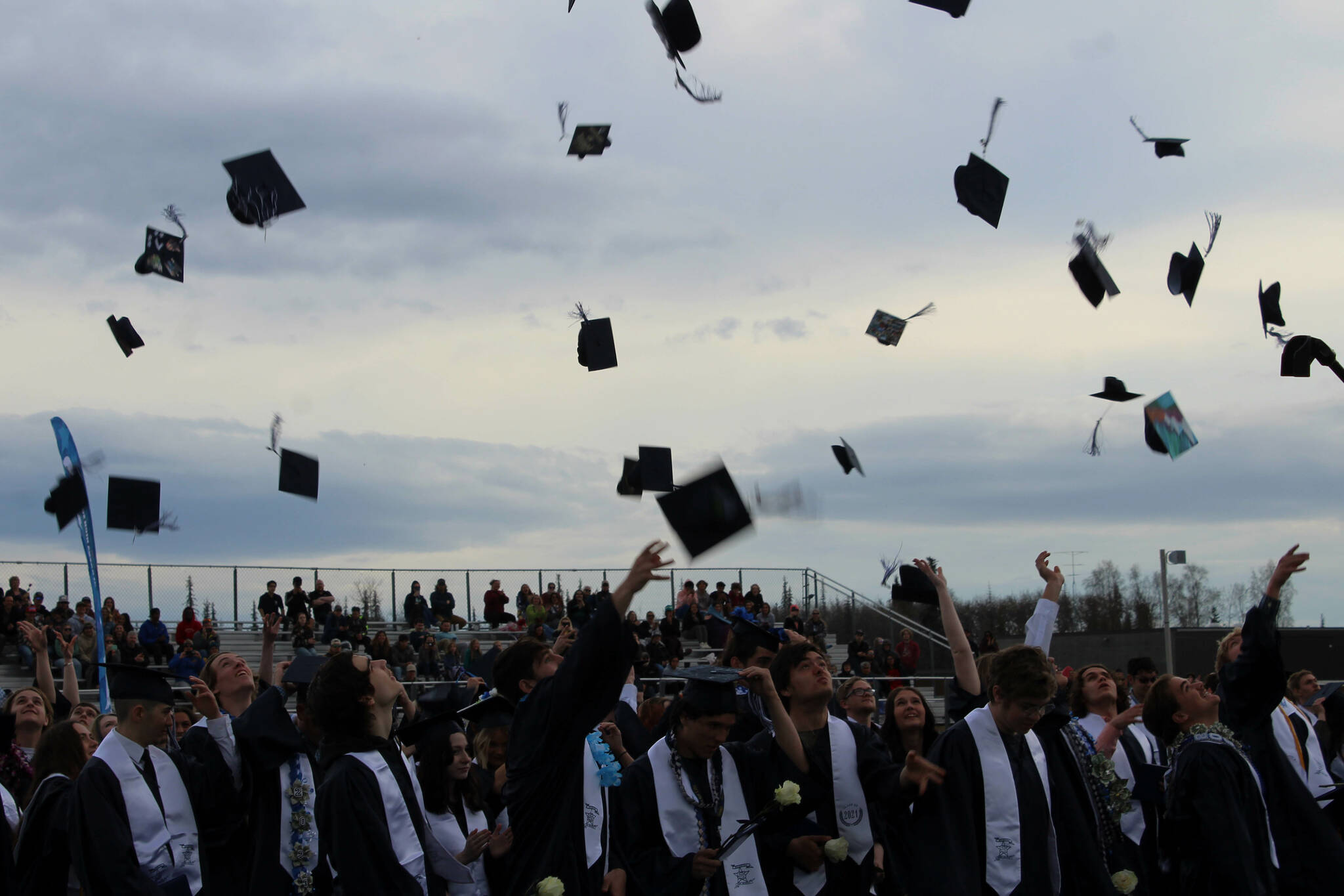 Soldotna High School graduates toss their caps during a ceremony on Monday, May 15, 2023, in Soldotna, Alaska. (Ashlyn O’Hara/Peninsula Clarion)