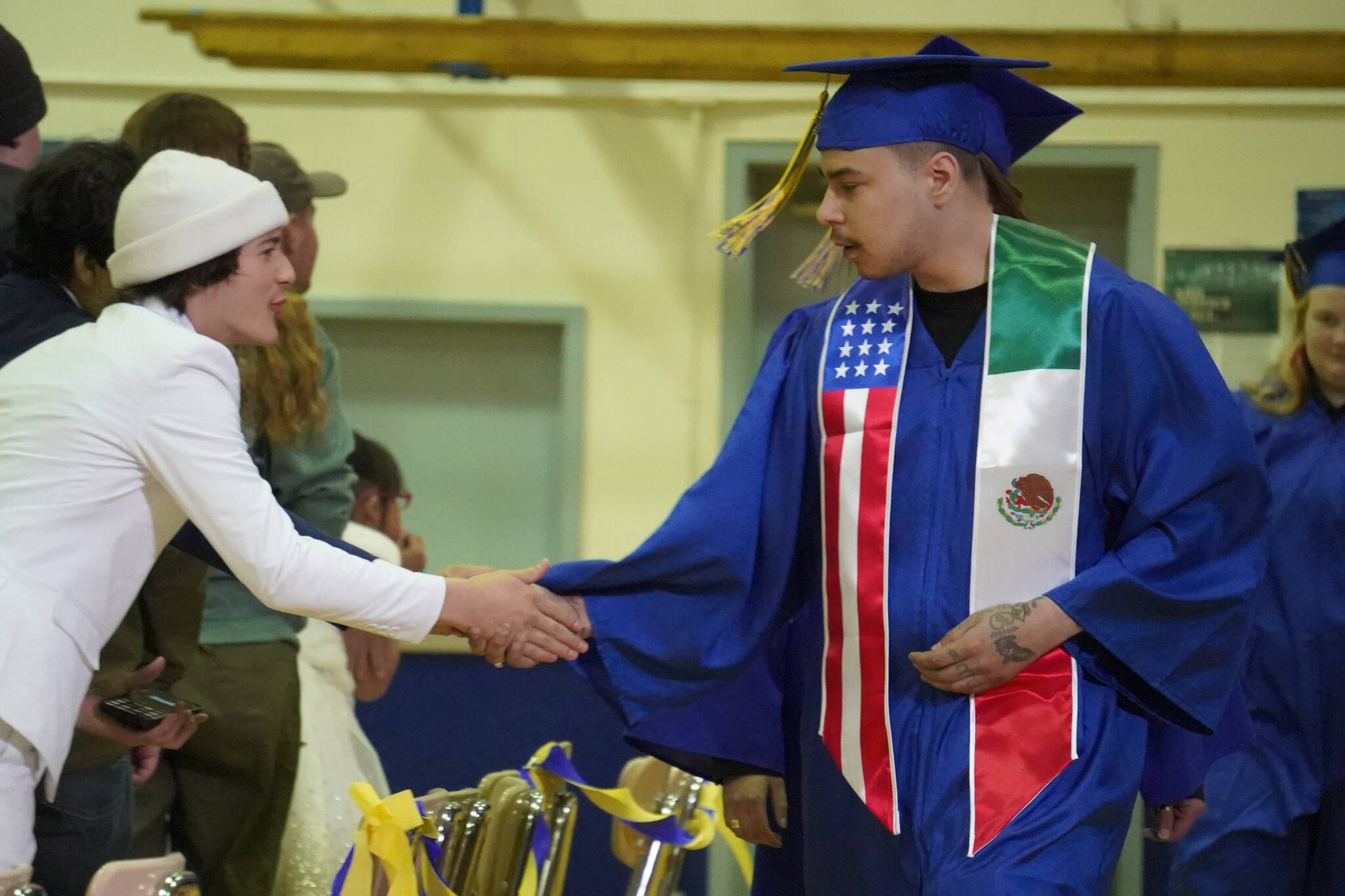 Graduates proceed into the gymnasium during a graduation ceremony on Monday, May 15, 2023, at Kenai Alternative High School in Kenai, Alaska. (Jake Dye/Peninsula Clarion)