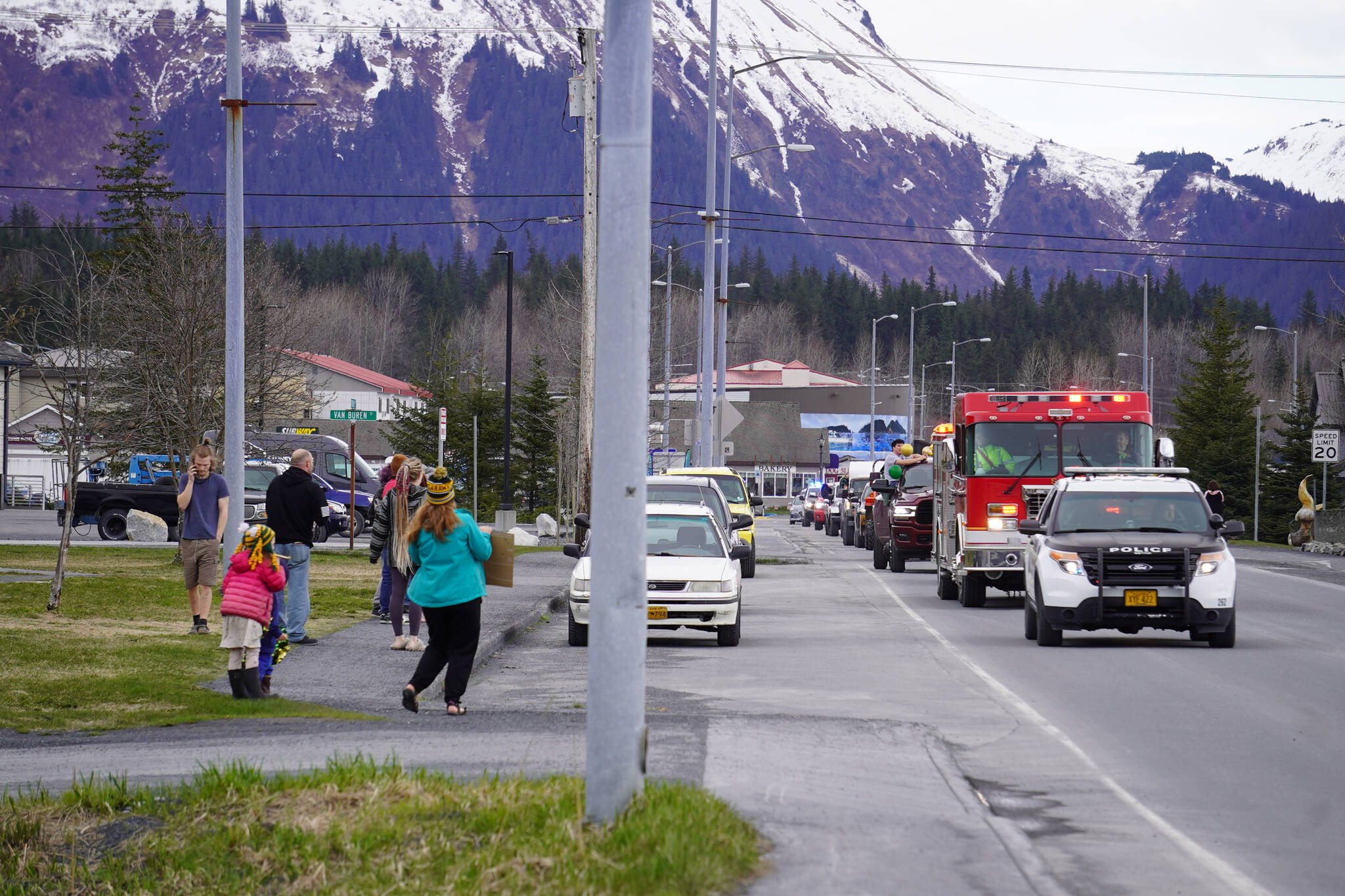 Seward residents gather along 4th Avenue in Seward, Alaska to see a parade of Seward High School seniors on Friday, May 12, 2023. (Jake Dye/Peninsula Clarion)