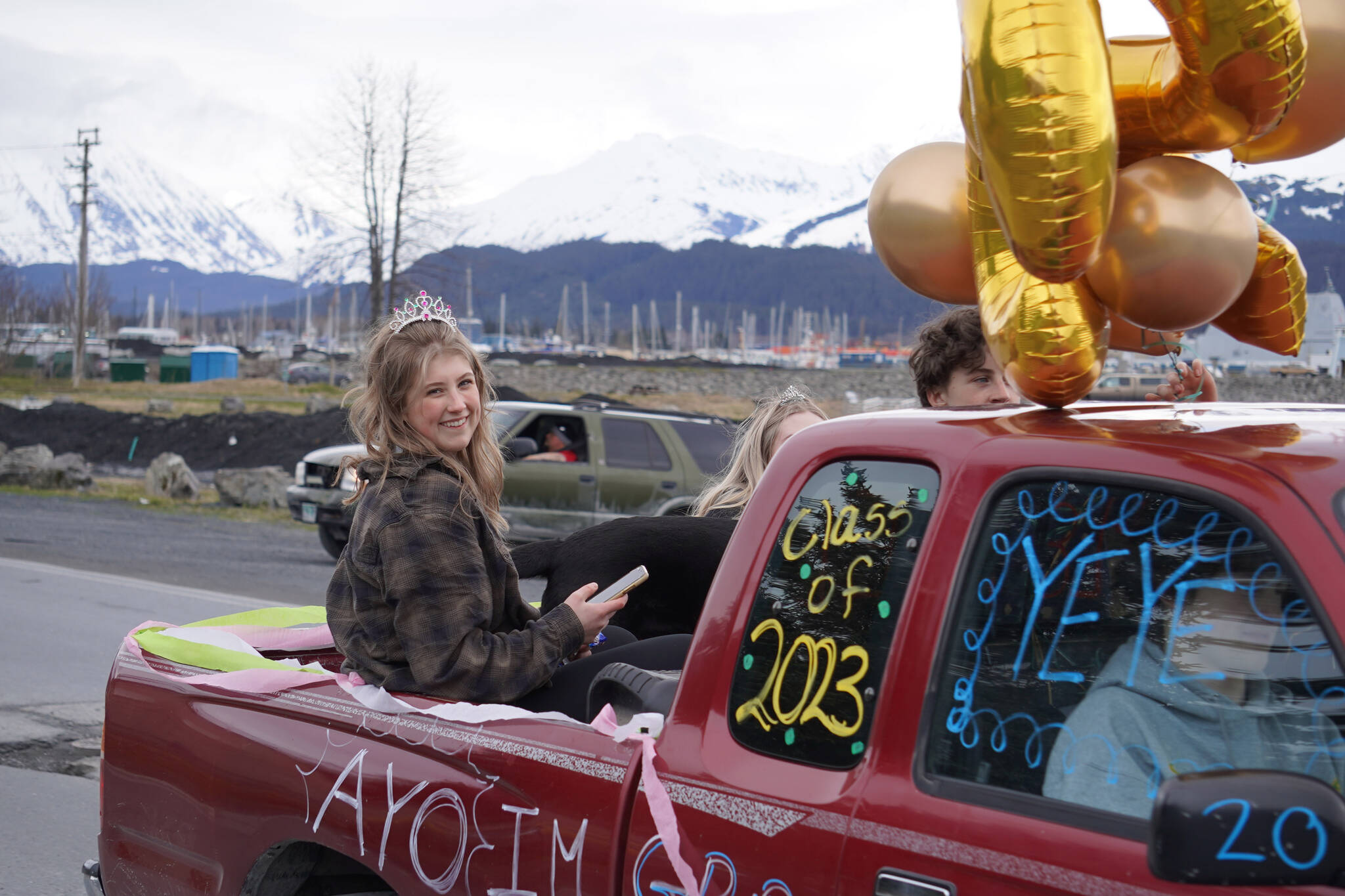 Seward graduate Renee Elhard parades down 4th Avenue in Seward, Alaska on Friday, May 12, 2023. (Jake Dye/Peninsula Clarion)