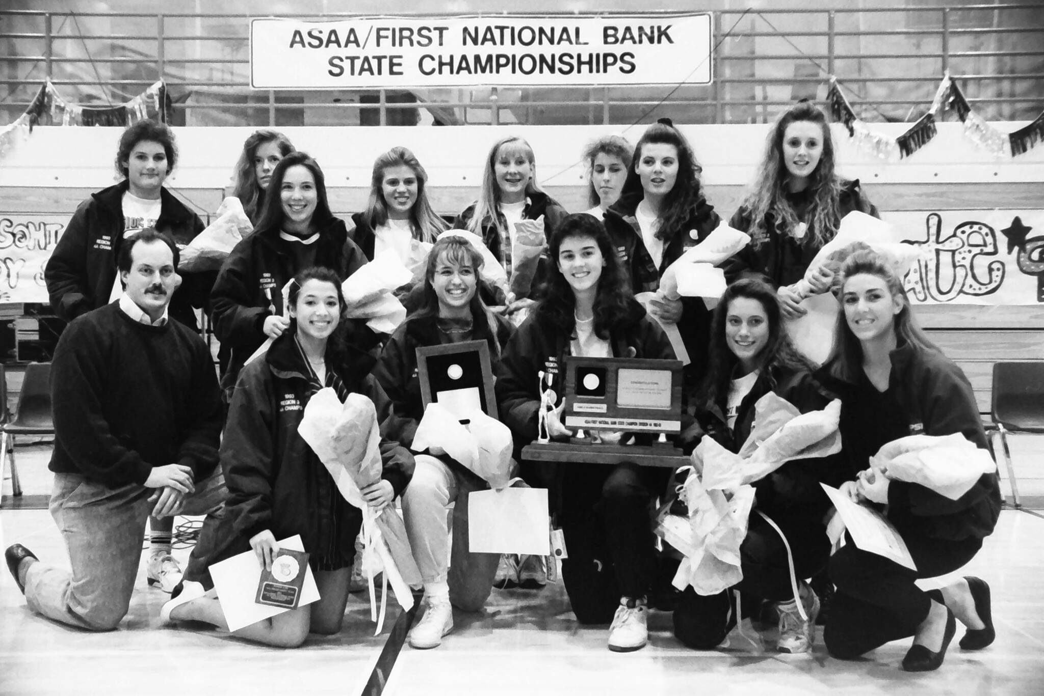 Coach Dan Gensel (front left) celebrates Soldotna High School’s first team-sport state championship on Friday, Feb. 12, 1993 in Soldotna, Alaska. Gensel, who led the Soldotna High School girls basketball team to victory, had promised his team earlier in the season that he would get his ear pierced if they won the state title. (Rusty Swan/Peninsula Clarion)