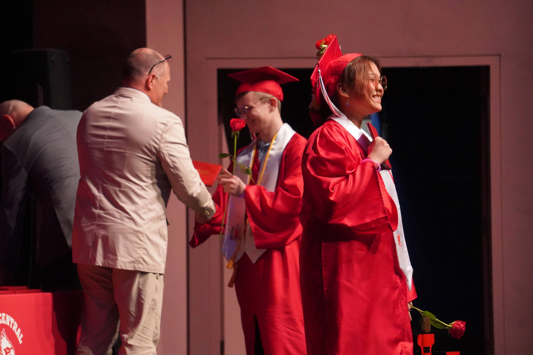 Kenai Central High School graduates receive their diplomas during a graduation ceremony on Wednesday, May 17, 2023, at Kenai Central High School in Kenai, Alaska. (Jake Dye/Peninsula Clarion)