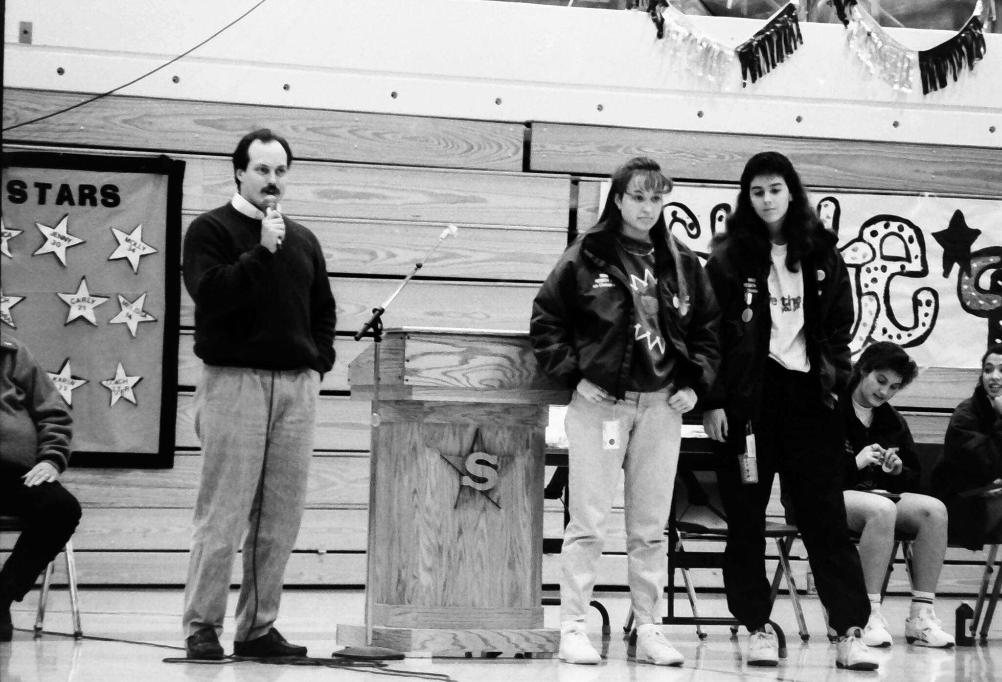 Coach Dan Gensel (left) prepares to get his ear pierced to celebrate Soldotna High School’s first team-sport state championship on Friday, Febr. 12, 1993 in Soldotna, Alaska. Gensel, who led the Soldotna High School girls basketball team to victory, had promised his team earlier in the season that he would get his ear pierced if they won the state title. (Rusty Swan/Peninsula Clarion)