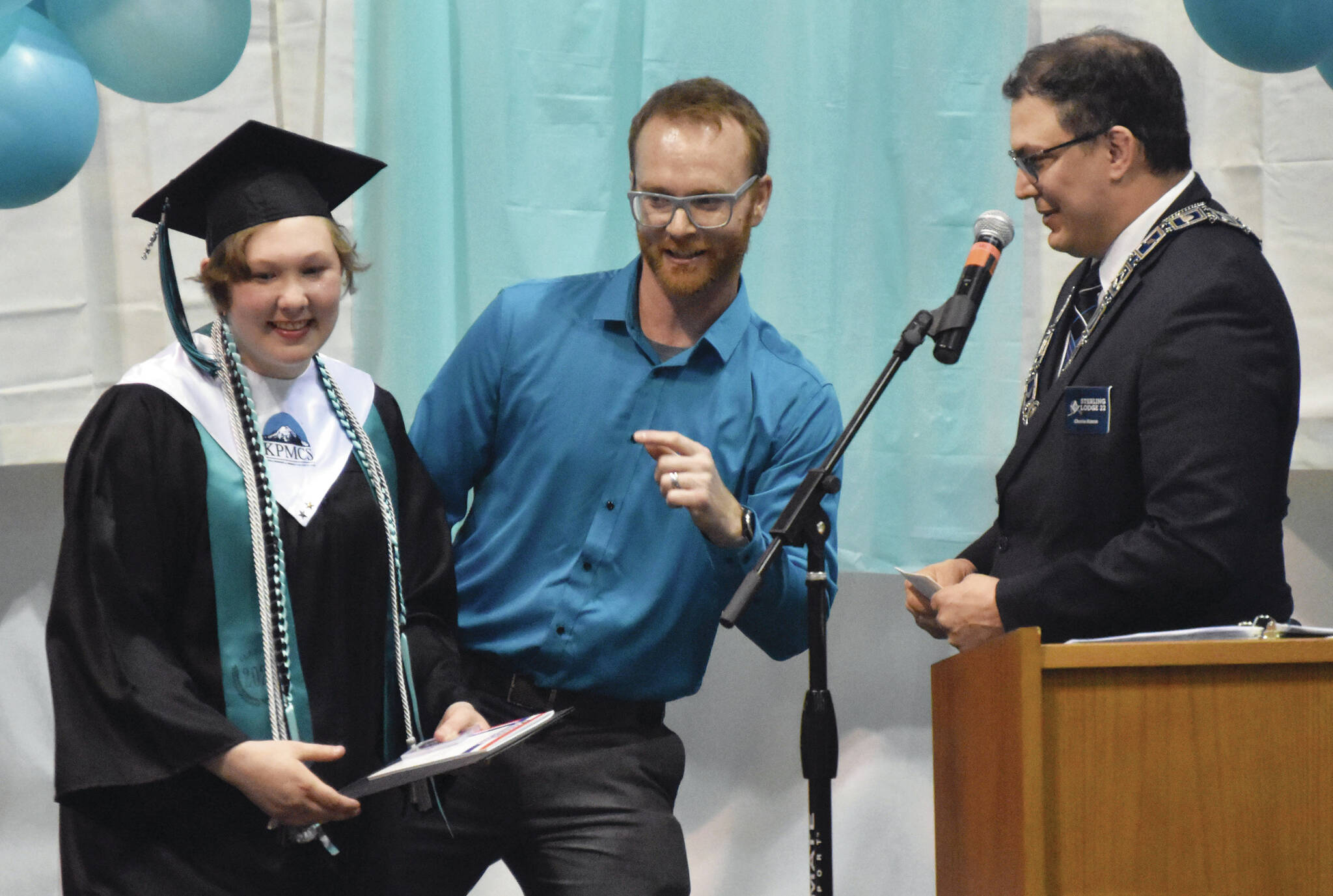 Hannah Crabtree accepts the Masonic Lodge Student of the Year award from Charles Karron (right) of Sterling Masonic Lodge #22 on Wednesday. Shea Nash, principal of River City Acadmey, orientates the two for photos. (Photo by Jeff Helminiak/Peninsula Clarion)