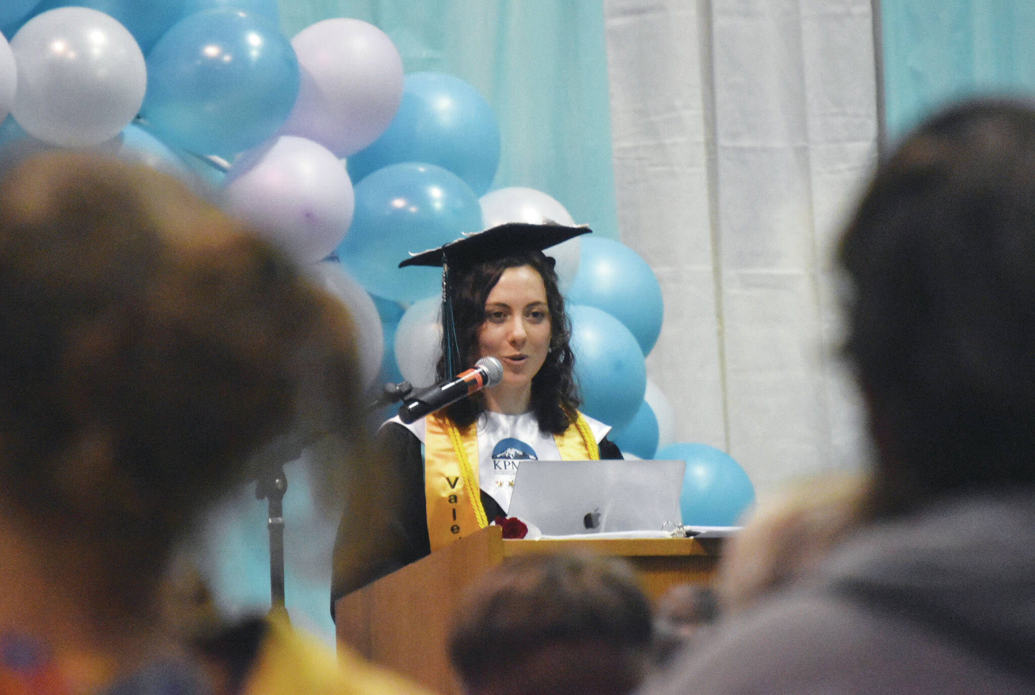 Valedictorian Elizabeth Rozeboom gives an address at the River City Academy graduation Wednesday at River City Academy inside Skyview Middle School. (Photo by Jeff Helminiak/Peninsula Clarion)