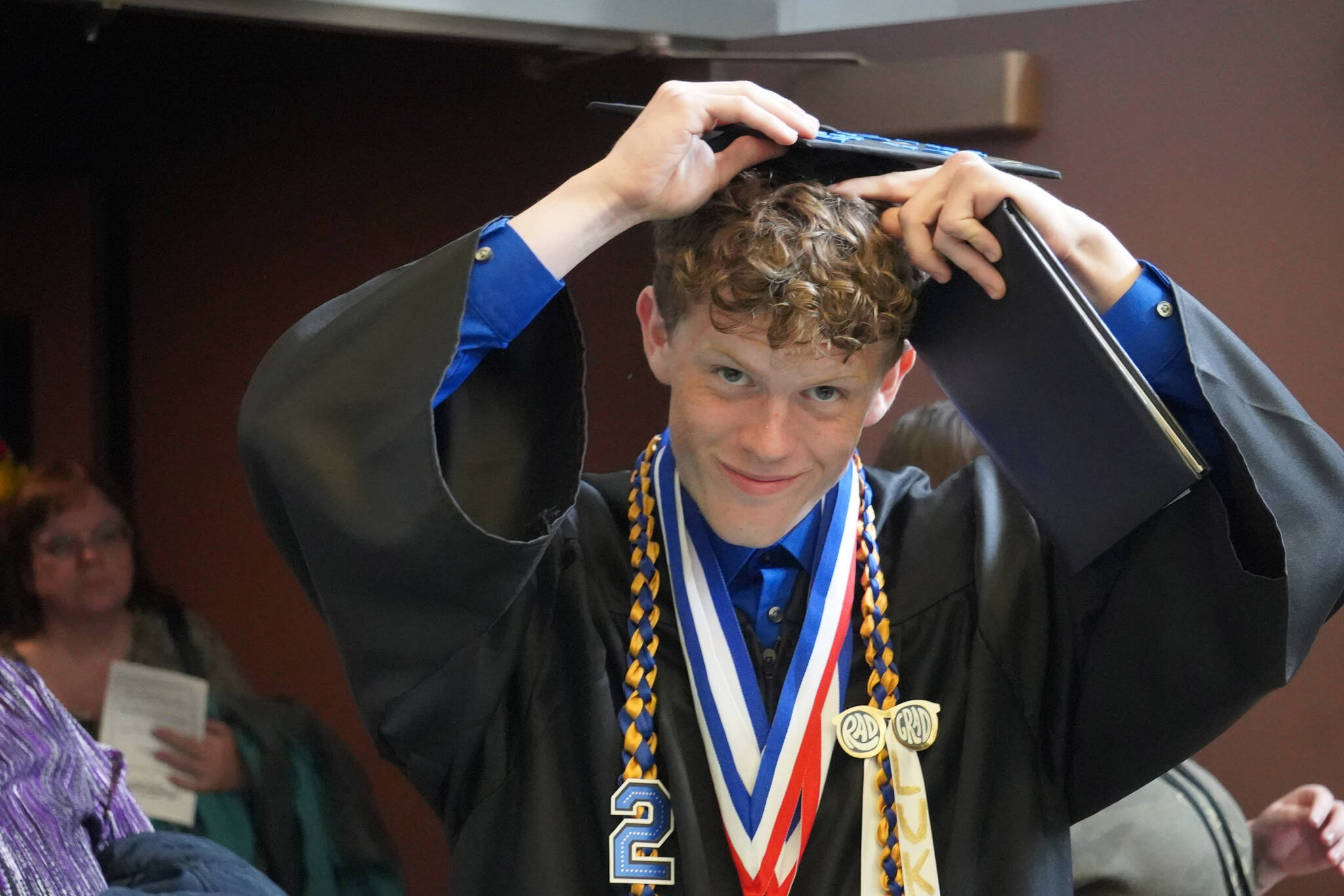 Graduates of Connections Homeschool exit the auditorium, diplomas in hand, after their graduation ceremony on Thursday, May 18, 2023, at Soldotna High School in Soldotna, Alaska. (Jake Dye/Peninsula Clarion)