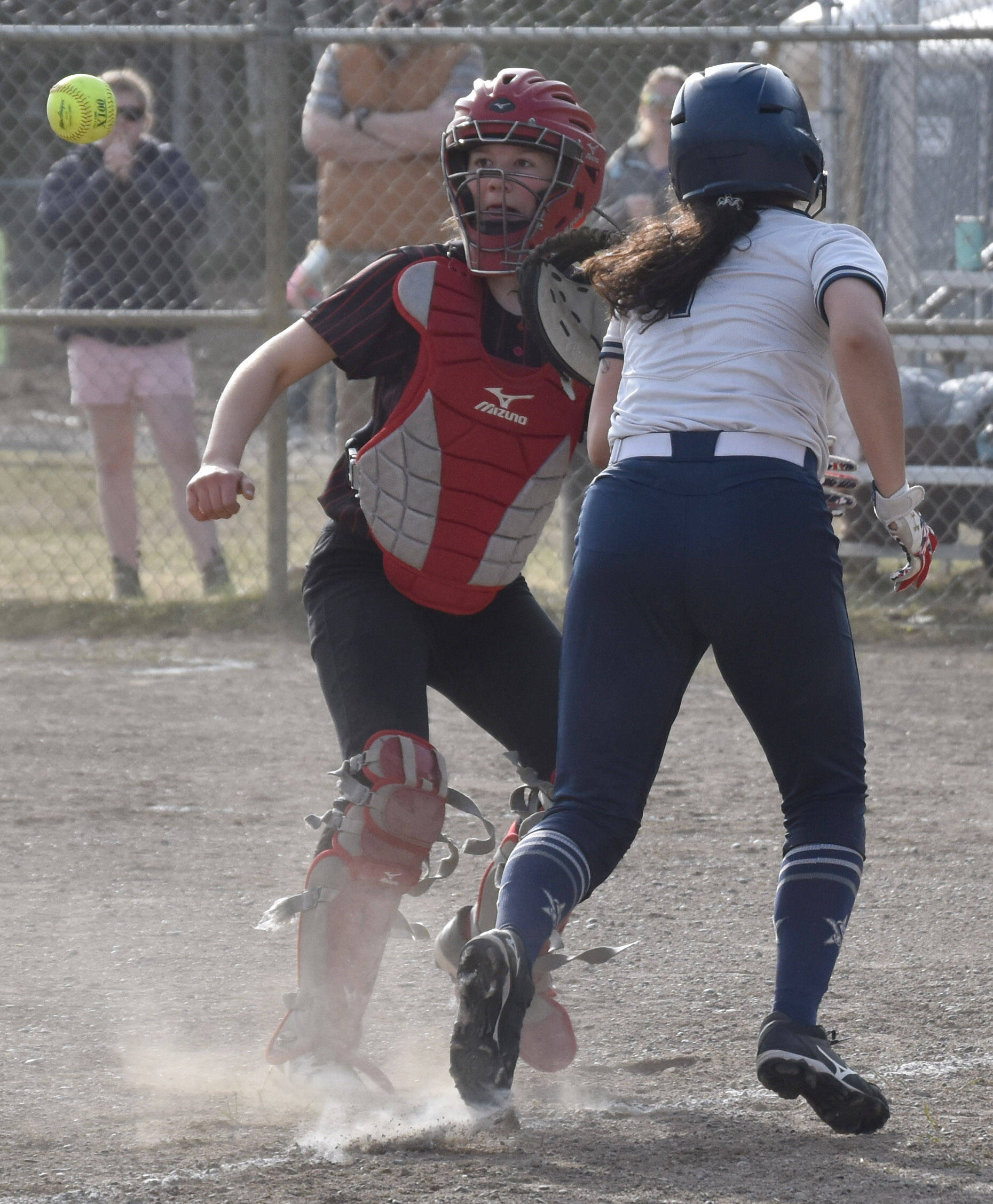 Kenai Central catcher Maggie Grenier gets ready to tag Soldotna’s Miah Mead to end a rundown Thursday, May 18, 2023, at the Soldotna Little League fields in Soldotna, Alaska. (Photo by Jeff Helminiak/Peninsula Clarion)