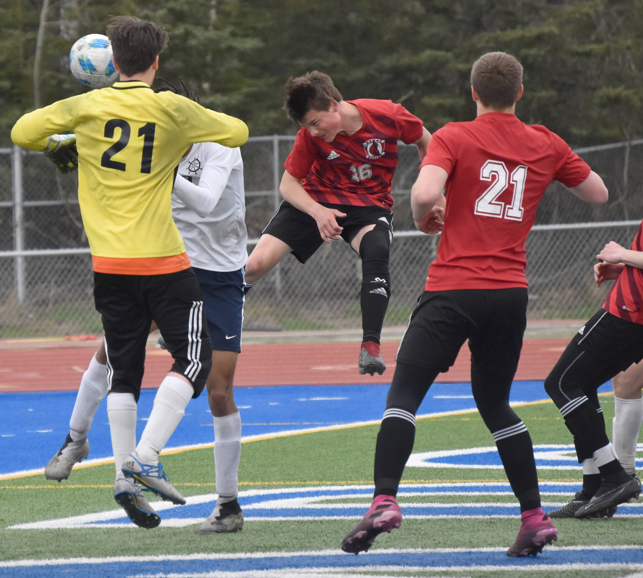 Kenai Central’s Sawyer Vann heads in the game-winning goal against Homer in the semifinals of the Peninsula Conference tournament Friday, May 19, 2023, at Justin Maile Field at Soldotna High School in Soldotna, Alaska. (Photo by Jeff Helminiak/Peninsula Clarion)