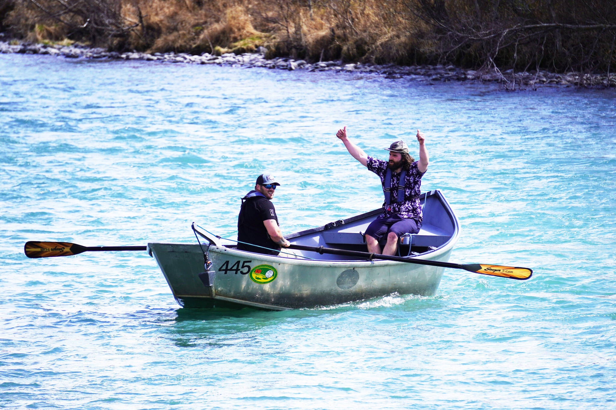 Contestants celebrate after completing the 16th Annual Cooper Landing Drift Boat Regatta at Sportsman’s Landing in Cooper Landing, Alaska, on Saturday, May 20, 2023. (Jake Dye/Peninsula Clarion)