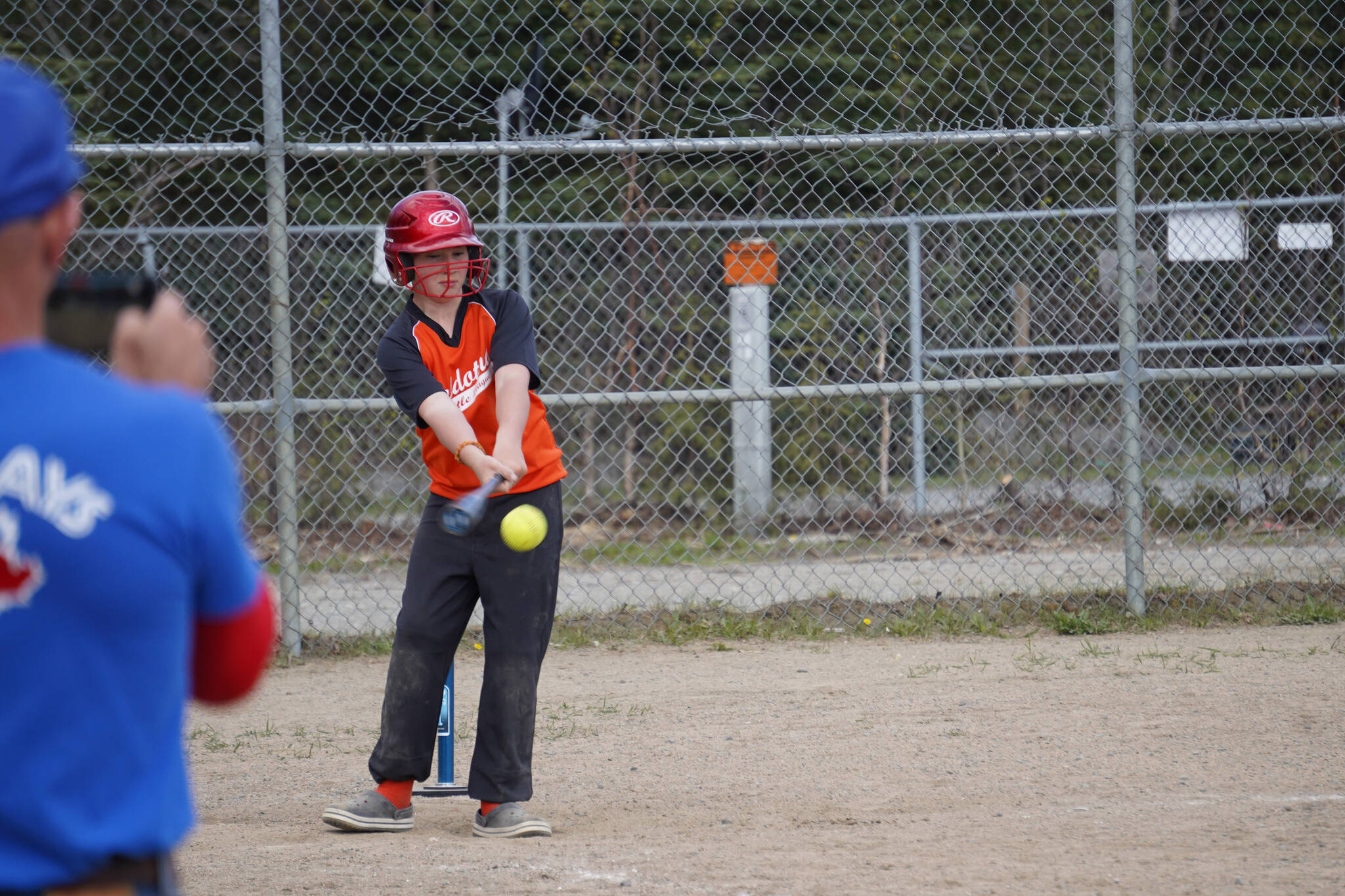 Paxton Katzenberger takes a swing at the ball in Soldotna Little League Challenger Program play at the Little League Fields in Soldotna, Alaska on Saturday, May 20, 2023. (Jake Dye/Peninsula Clarion)
