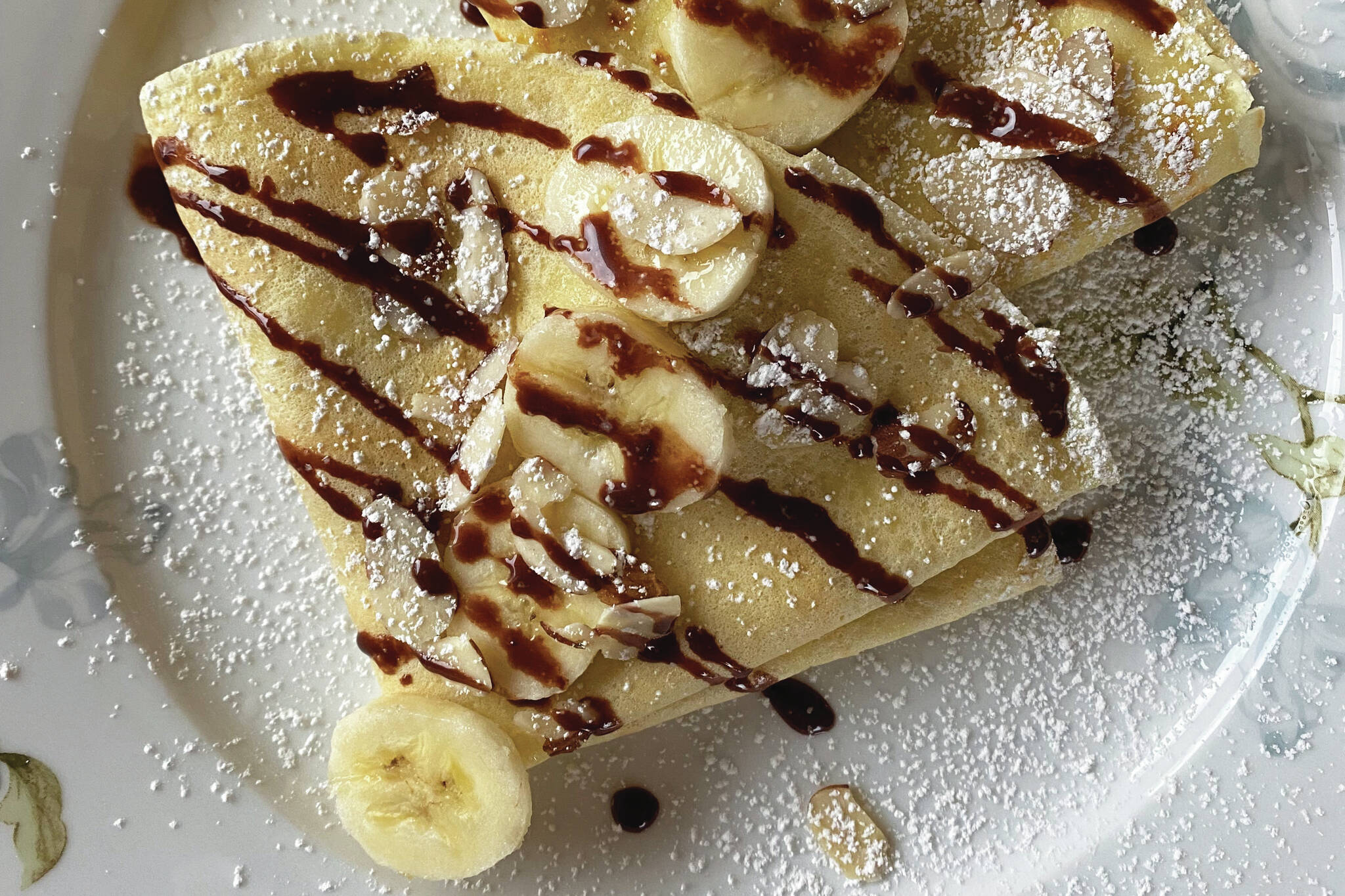 The simple yet versatile crepe can be served savory or sweet, such as this banana, powdered sugar and chocolate creation. (Photo by Tressa Dale/Peninsula Clarion)