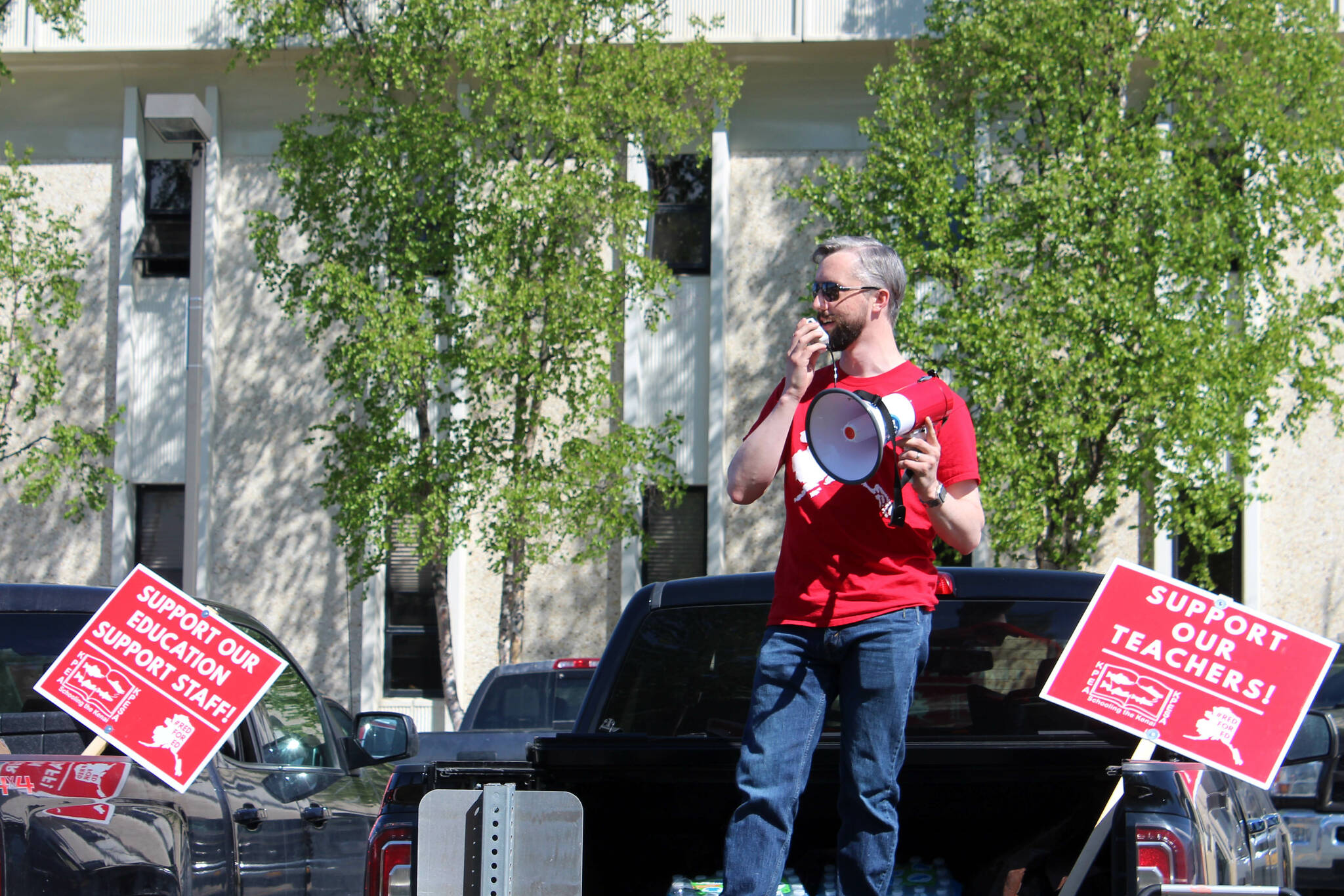 Kenai Peninsula Education Association President Nathan Erfurth speaks from the bed of his truck in support of Kenai Peninsula Borough School District teachers and support staff outside of the George A. Navarre Admin Building on Thursday, May 26, 2022, in Soldotna, Alaska. Erfurth was removed this week as president of the Kenai Peninsula Borough School District’s teachers union, days after he was arrested Saturday on two charges of sexual abuse of a minor. (Ashlyn O’Hara/Peninsula Clarion)