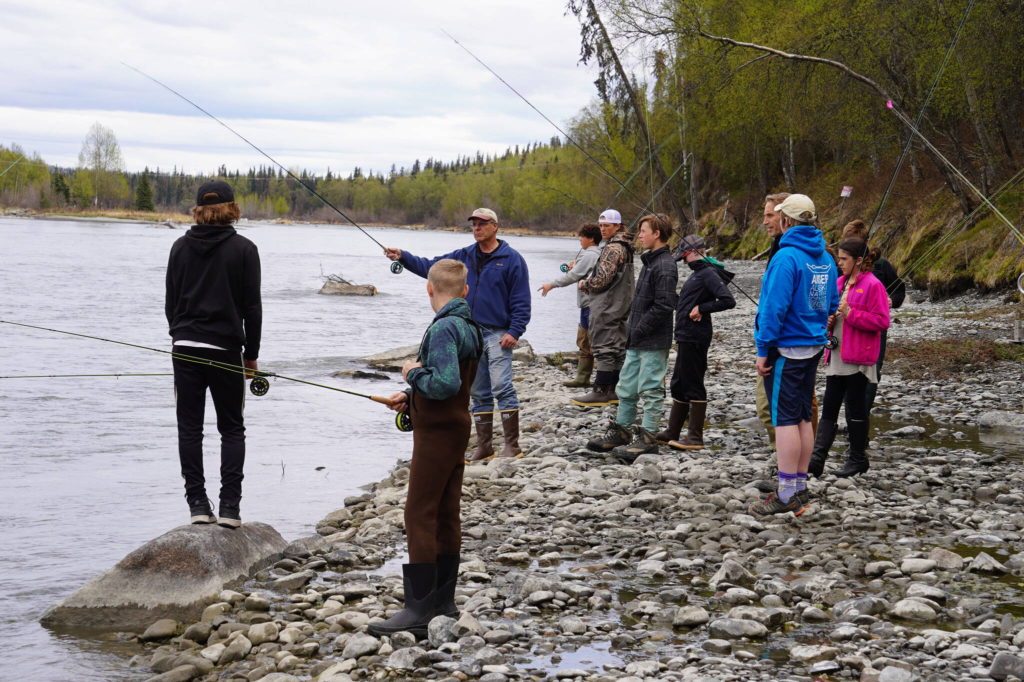 Dave Atcheson demonstrates fly casting into the Kenai River to a crowd of middle schoolers during a kids camp put on by Trout Unlimited on Wednesday, May 24, 2023, at the Donald E. Gilman Kenai River Center in Soldotna, Alaska. (Jake Dye/Peninsula Clarion)