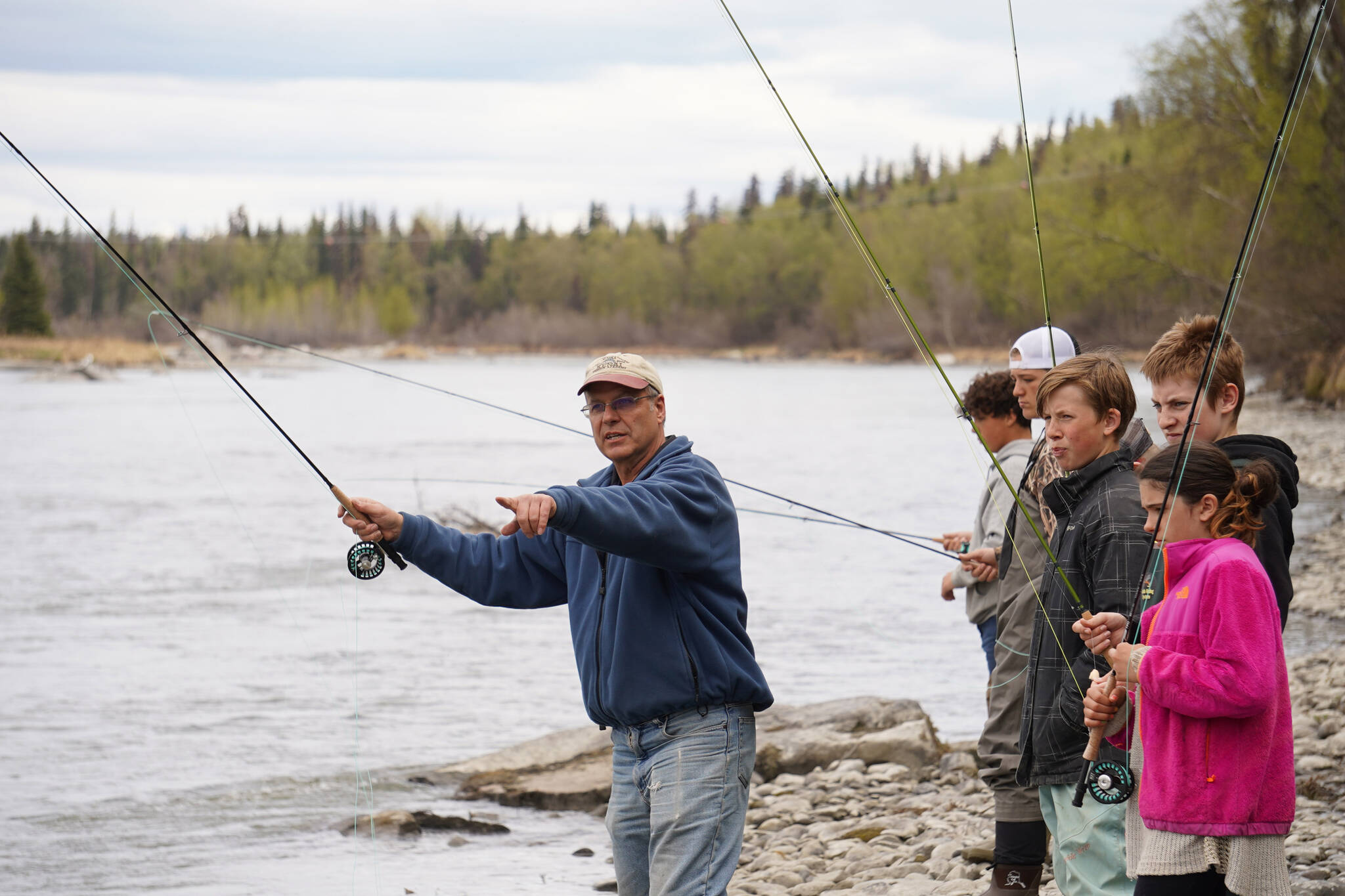 Dave Atcheson demonstrates fly casting into the Kenai River to a crowd of middle schoolers during a kids camp put on by Trout Unlimited on Wednesday, May 24, 2023, at the Donald E. Gilman Kenai River Center in Soldotna, Alaska. (Jake Dye/Peninsula Clarion)