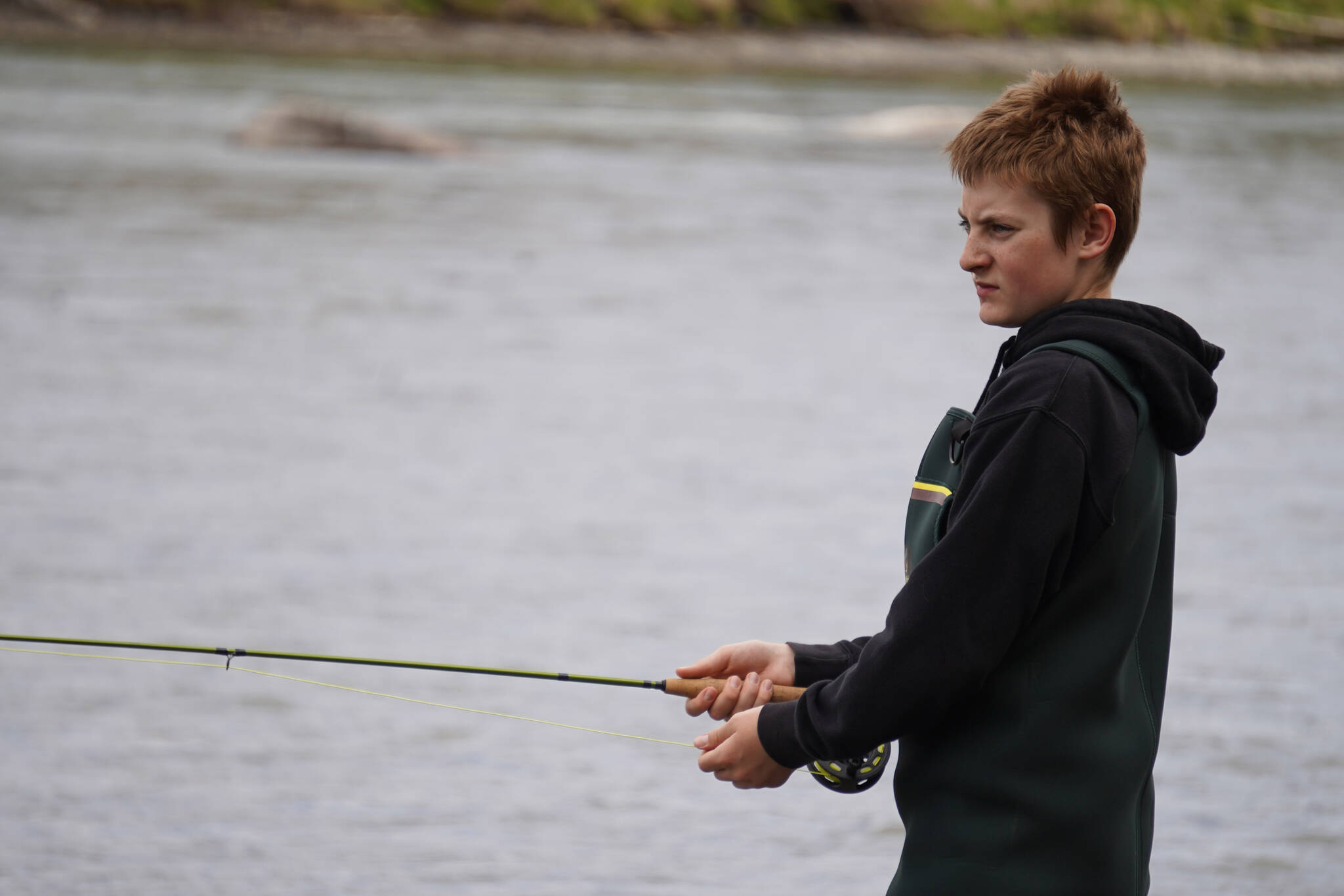 Middle schoolers practice fly casting into the Kenai River during a kids camp put on by Trout Unlimited on Wednesday, May 24, 2023, at the Donald E. Gilman Kenai River Center in Soldotna, Alaska. (Jake Dye/Peninsula Clarion)