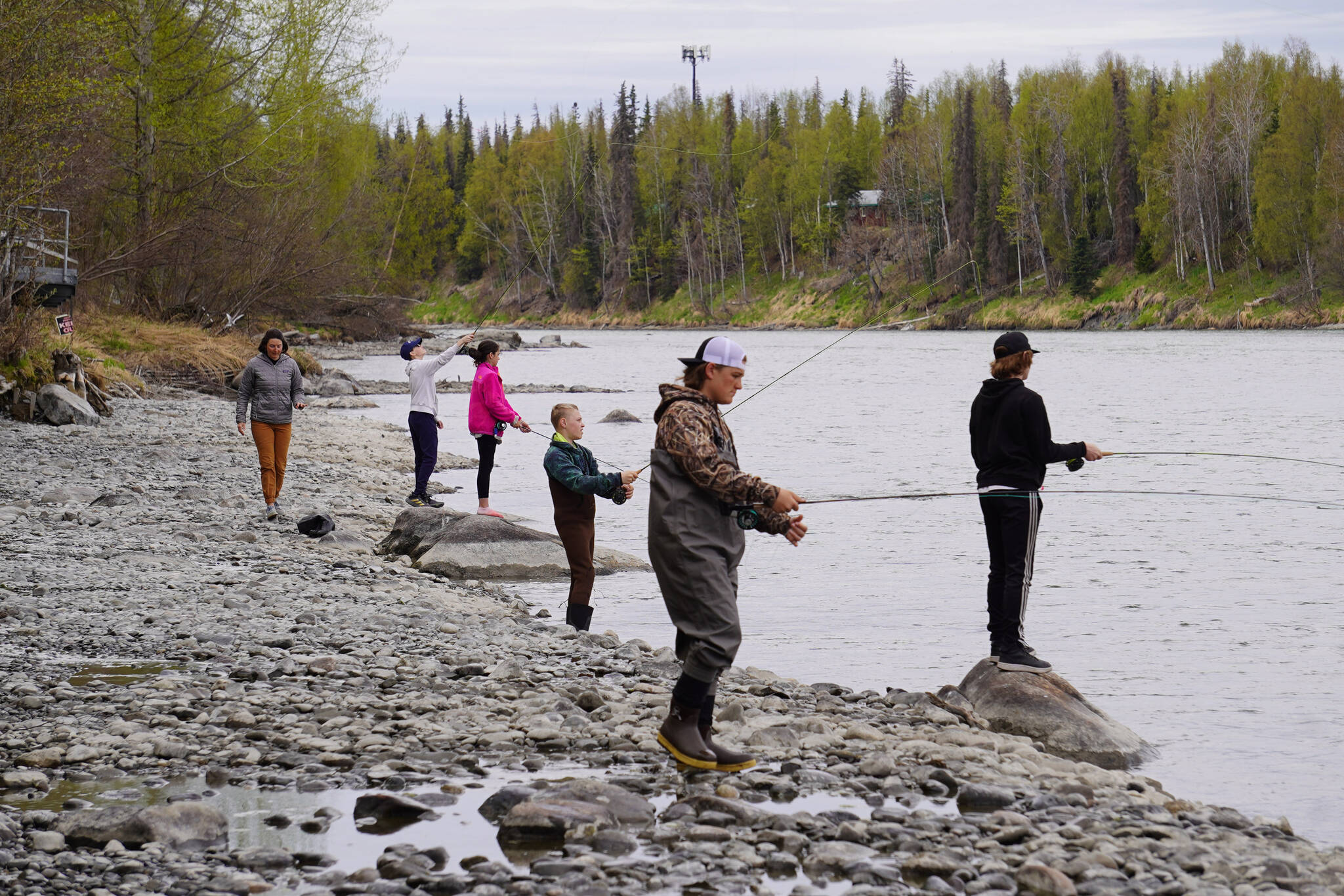 Middle schoolers practice fly casting into the Kenai River during a kids camp put on by Trout Unlimited on Wednesday, May 24, 2023, at the Donald E. Gilman Kenai River Center in Soldotna, Alaska. (Jake Dye/Peninsula Clarion)