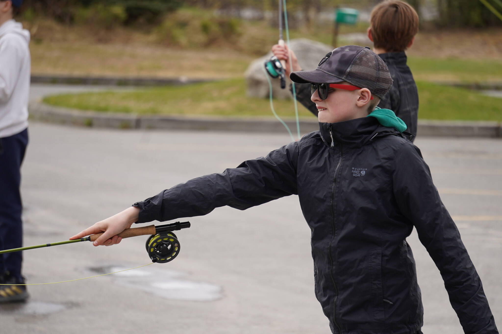 Middle schoolers practice fly casting in the parking lot of the Donald E. Gilman Kenai River Center in Soldotna, Alaska, during a kids camp put on by Trout Unlimited on Wednesday, May 24, 2023. (Jake Dye/Peninsula Clarion)