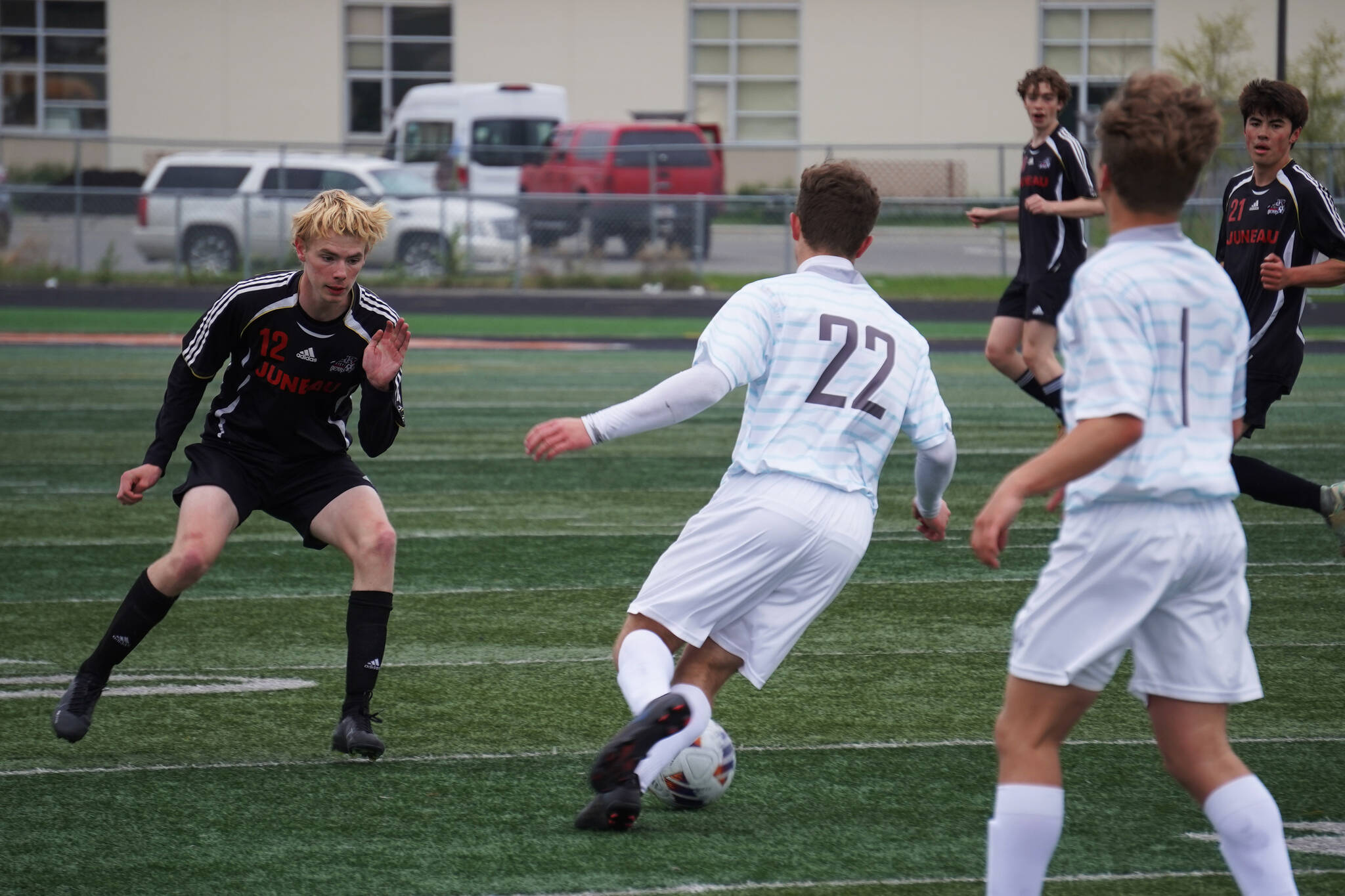 Juneau-Douglas’ Will Robinson moves to attack the ball, under the control of Soldotna’s Zachary Buckbee, during the Division II Soccer State Championship on Saturday, May 27, 2023, at West Anchorage High School in Anchorage, Alaska. (Jake Dye/Peninsula Clarion)