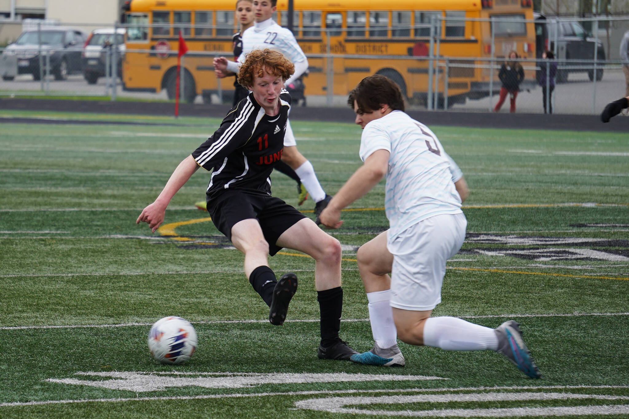 Juneau-Douglas’s Emmett Mesdag battles for the ball with Soldotna’s Gehret Medcoff during the Division II Soccer State Championship on Saturday, May 27, 2023, at West Anchorage High School in Anchorage, Alaska. (Jake Dye/Peninsula Clarion)