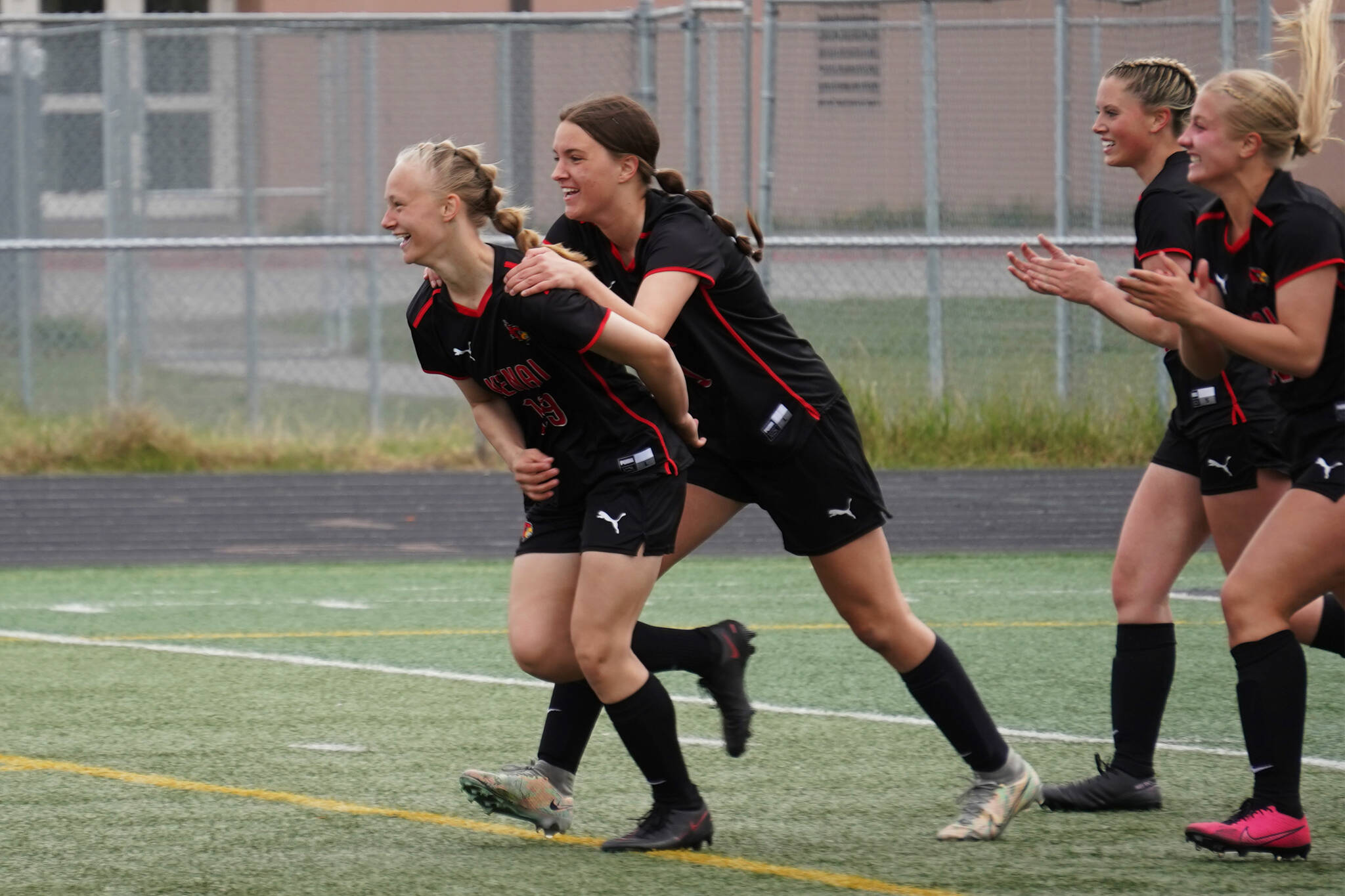 Kenai Central’s Rylie Sparks and Ella Yragui celebrate after Sparks scored their first goal of the game during the Division II Soccer State Championship on Saturday, May 27, 2023, at West Anchorage High School in Anchorage, Alaska. (Jake Dye/Peninsula Clarion)