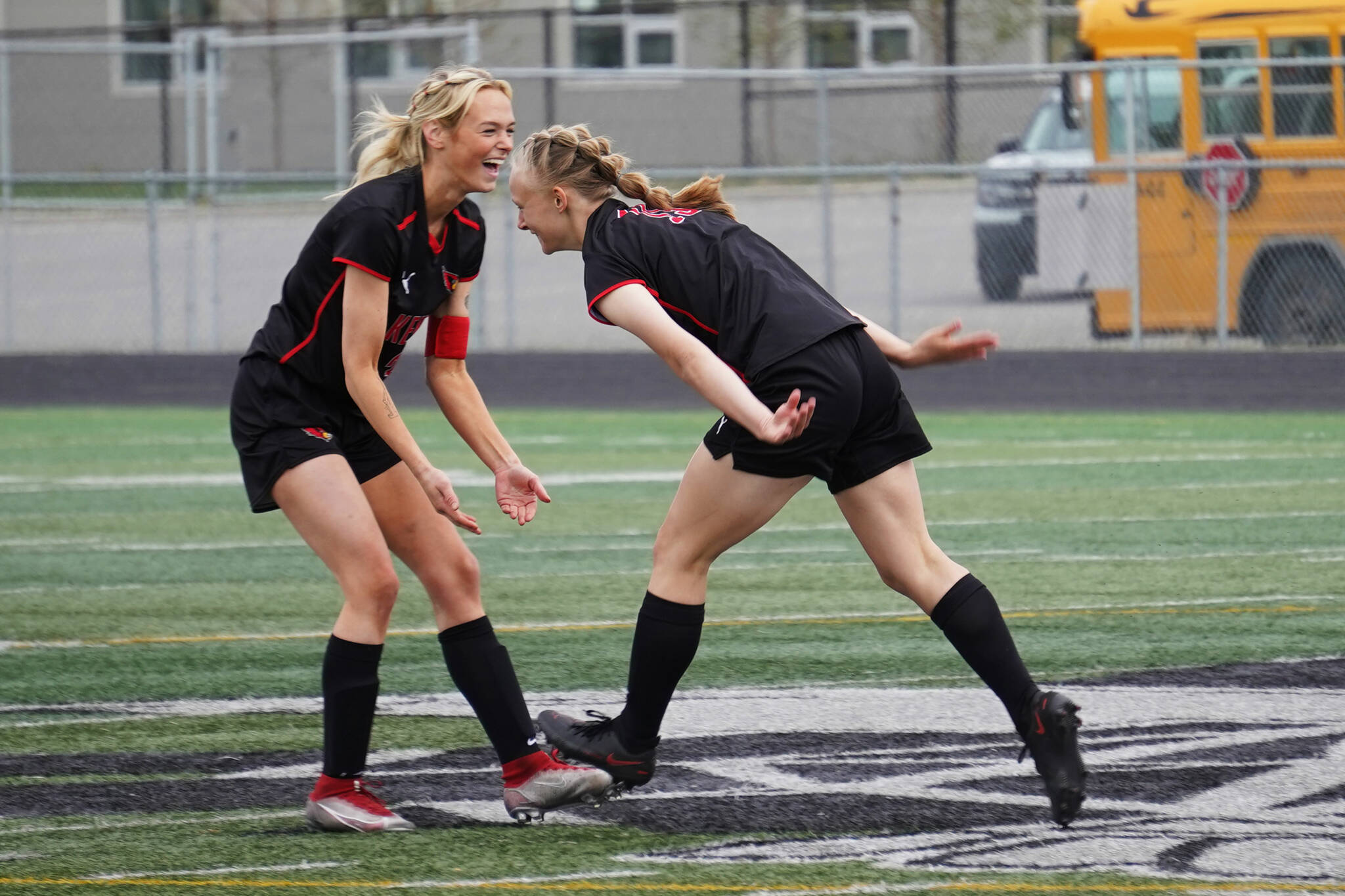 Kenai Central’s Calani Holmes and Rylie Sparks celebrate after Sparks scored their first goal of the game during the Division II Soccer State Championship on Saturday, May 27, 2023, at West Anchorage High School in Anchorage, Alaska. (Jake Dye/Peninsula Clarion)