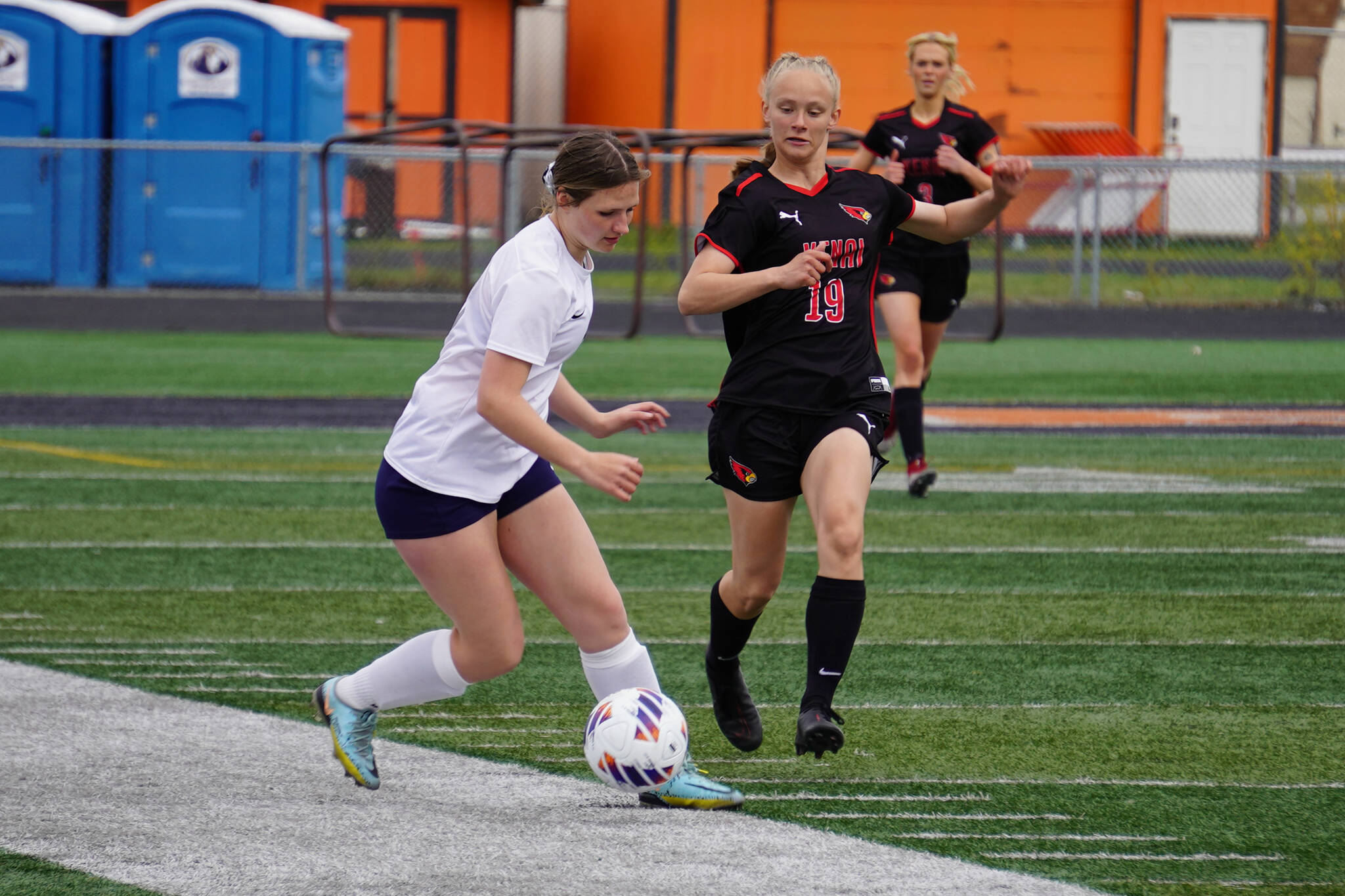 Soldotna’s Anika Jedlicka battles for the ball with Kenai Central’s Rylie Sparks during the Division II Soccer State Championship on Saturday, May 27, 2023, at West Anchorage High School in Anchorage, Alaska. (Jake Dye/Peninsula Clarion)