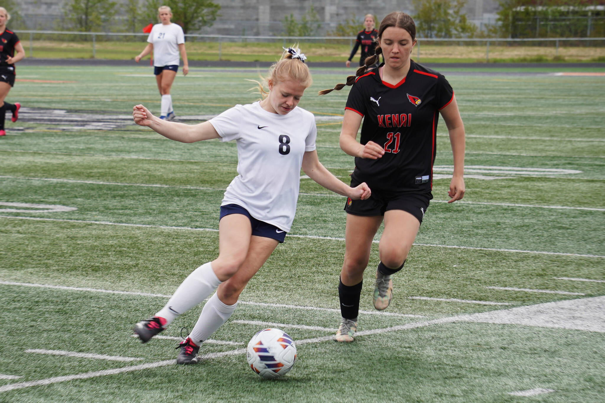 Soldotna’s Keely Sundberg battles for the ball with Kenai Central’s Ella Yragui during the Division II Soccer State Championship on Saturday, May 27, 2023, at West Anchorage High School in Anchorage, Alaska. (Jake Dye/Peninsula Clarion)