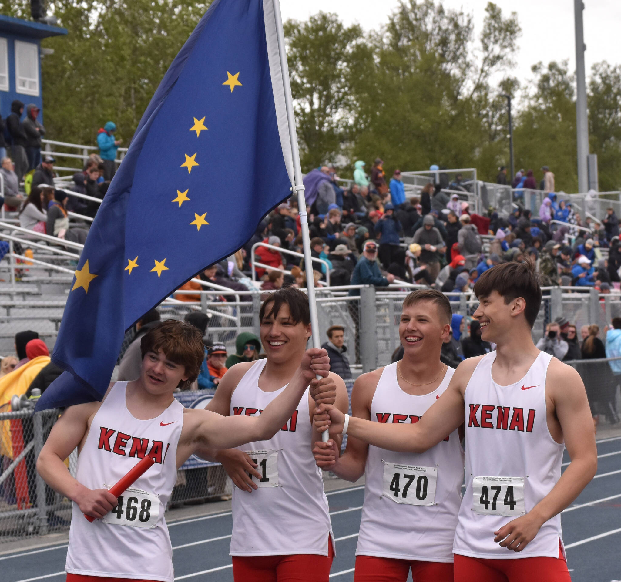 Kenai Central’s Reagan Graves, Robert Hayes, Ransom Hayes and Daniel McRorie celebrate victory in the Division II 400-meter relay Saturday, May 27, 2023, at the state track and field meet at Palmer High School in Palmer, Alaska. (Photo by Jeff Helminiak/Peninsula Clarion)