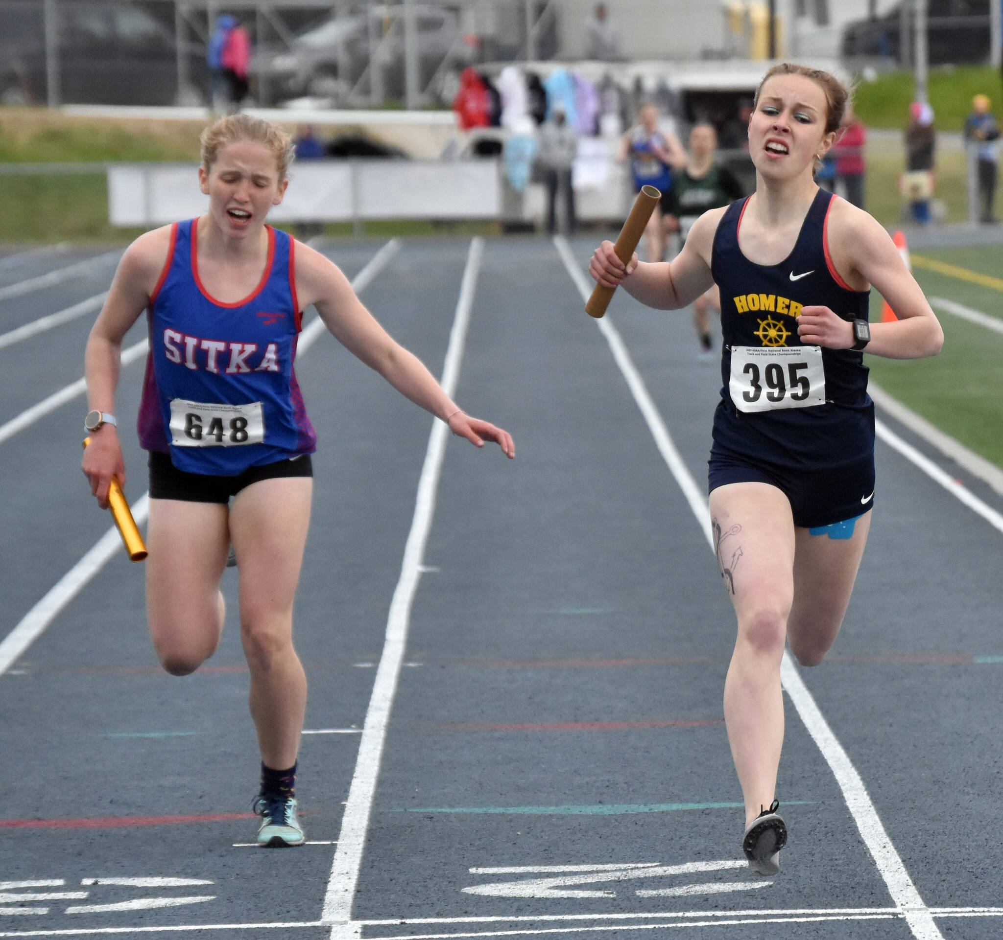 Homer’s Eryn Field holds off Sitka’s Clare Mullin to win the Division II 1,600-meter relay Saturday, May 27, 2023, at the state track and field meet at Palmer High School in Palmer, Alaska. (Photo by Jeff Helminiak/Peninsula Clarion)