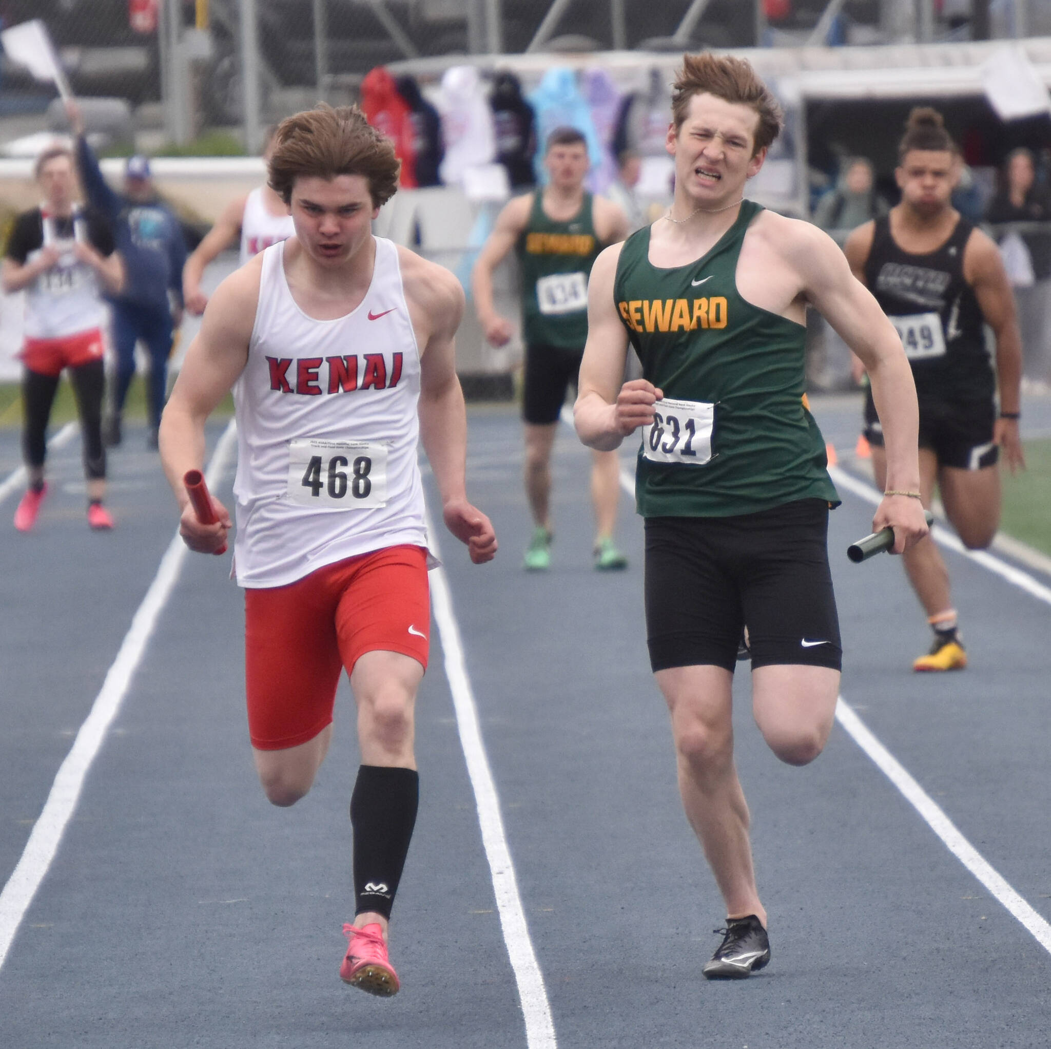 Kenai Central’s Reagan Graves and Seward’s Emerson Cross battle in the Division II 400-meter relay Saturday, May 27, 2023, at the state track and field meet at Palmer High School in Palmer, Alaska. (Photo by Jeff Helminiak/Peninsula Clarion)
