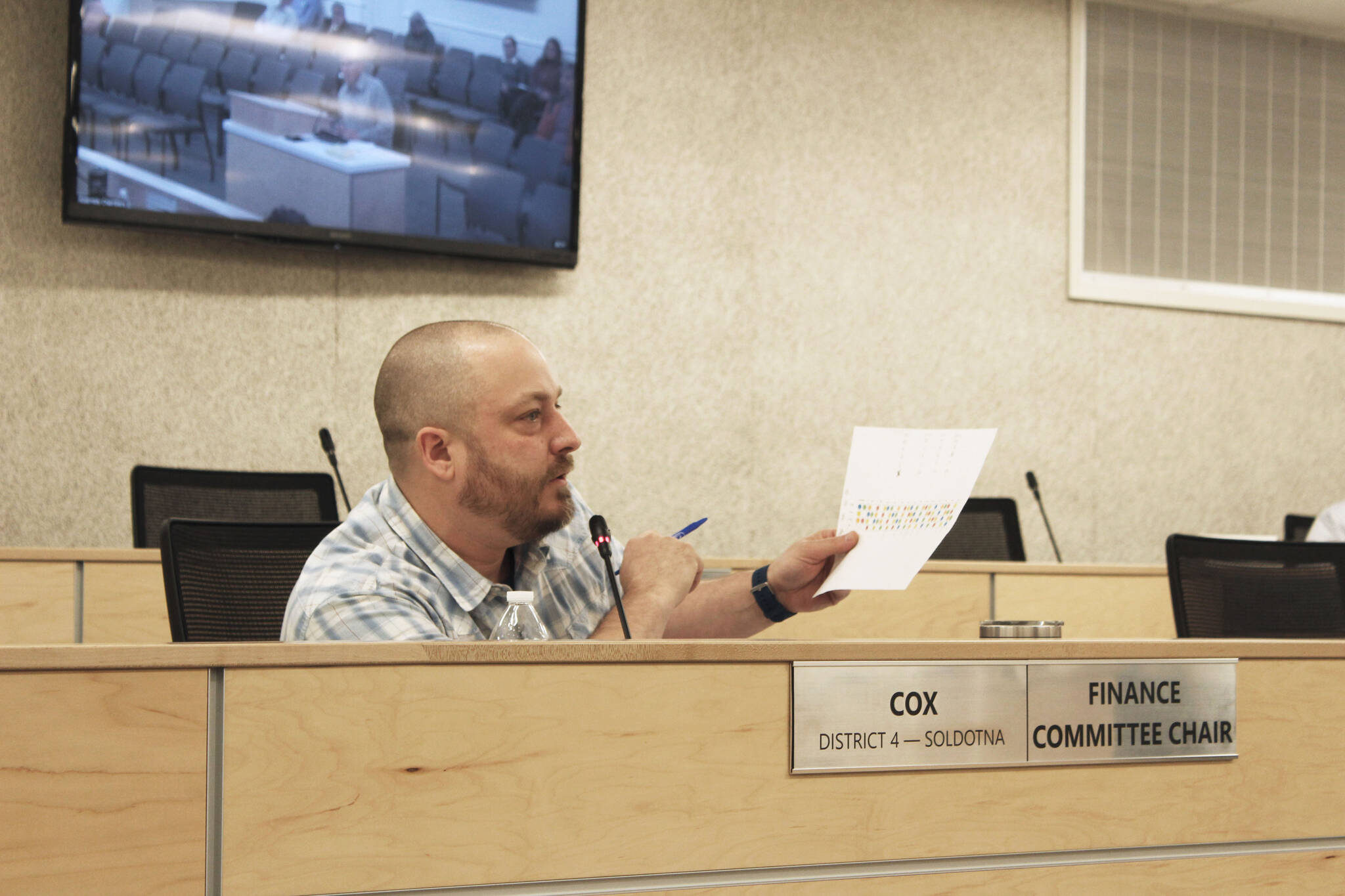 Tyson Cox references a sheet illustrating the rotation of seats on the Kenai Peninsula Borough Planning Commission during a meeting of the Kenai Peninsula Borough Assembly on Tuesday, Dec. 7, 2021, in Soldotna, Alaska. (Ashlyn O’Hara/Peninsula Clarion)