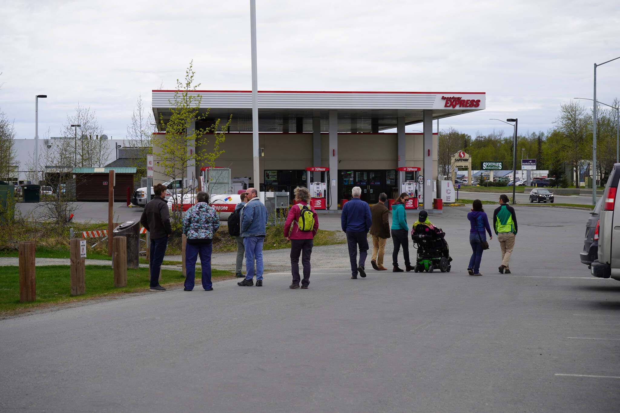A cohort of transportation professionals splits into parties and begins a tour of the Sterling Highway and Birch Avenue intersection in Soldotna, Alaska, on Monday, May 22, 2023. (Jake Dye/Peninsula Clarion)