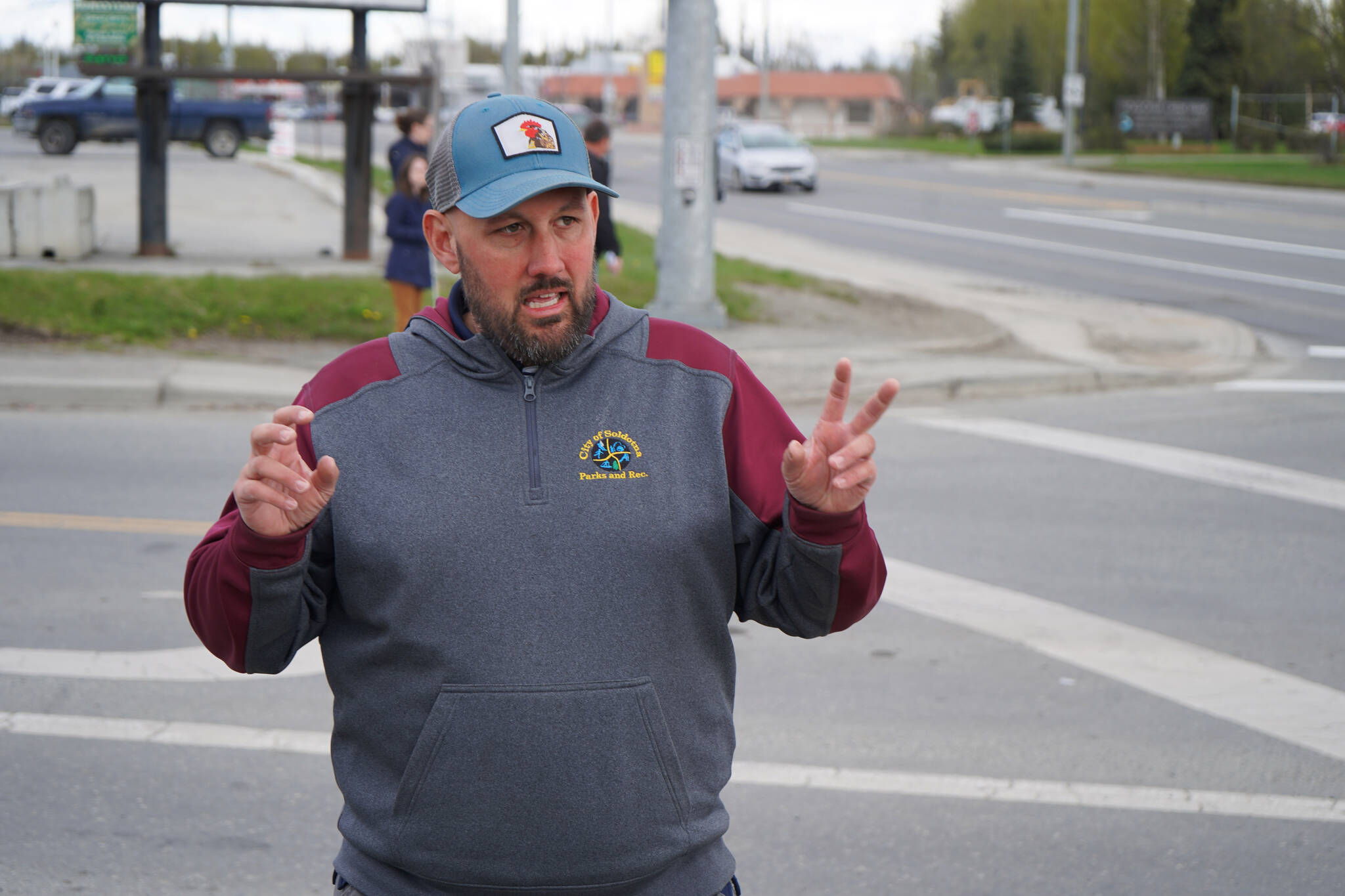 Soldotna Parks & Rec Director Joel Todd leads a party of transportation professionals on a tour of the Sterling Highway and Birch Avenue intersection in Soldotna, Alaska, on Monday, May 22, 2023. (Jake Dye/Peninsula Clarion)