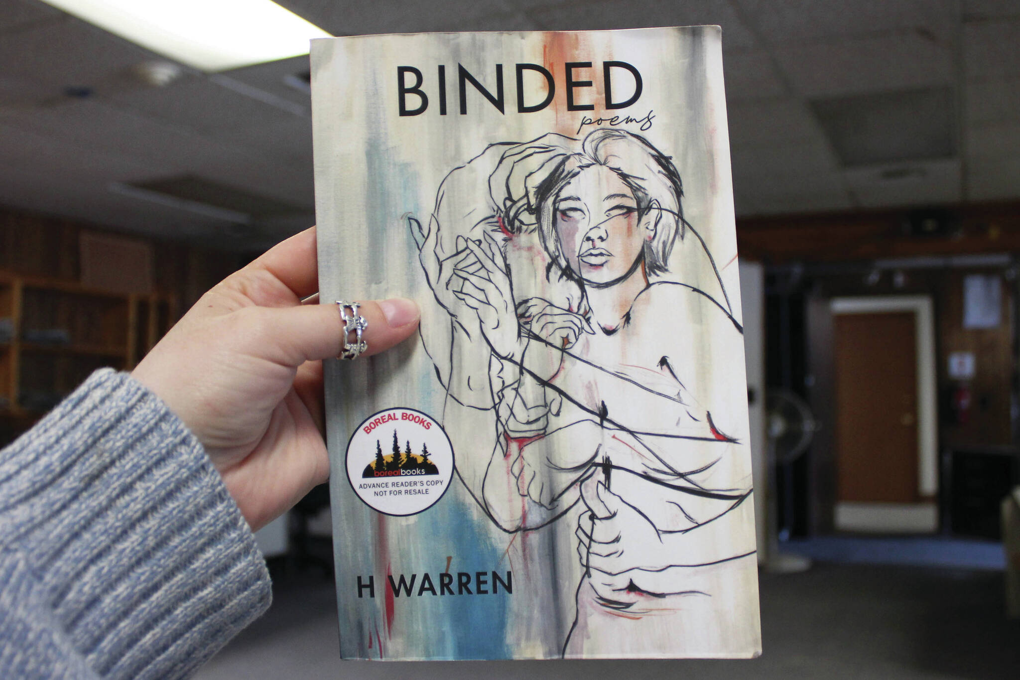 Ashlyn O’Hara/Peninsula Clarion
A copy of H Warren’s “Binded” is held in the Peninsula Clarion building on Thursday.