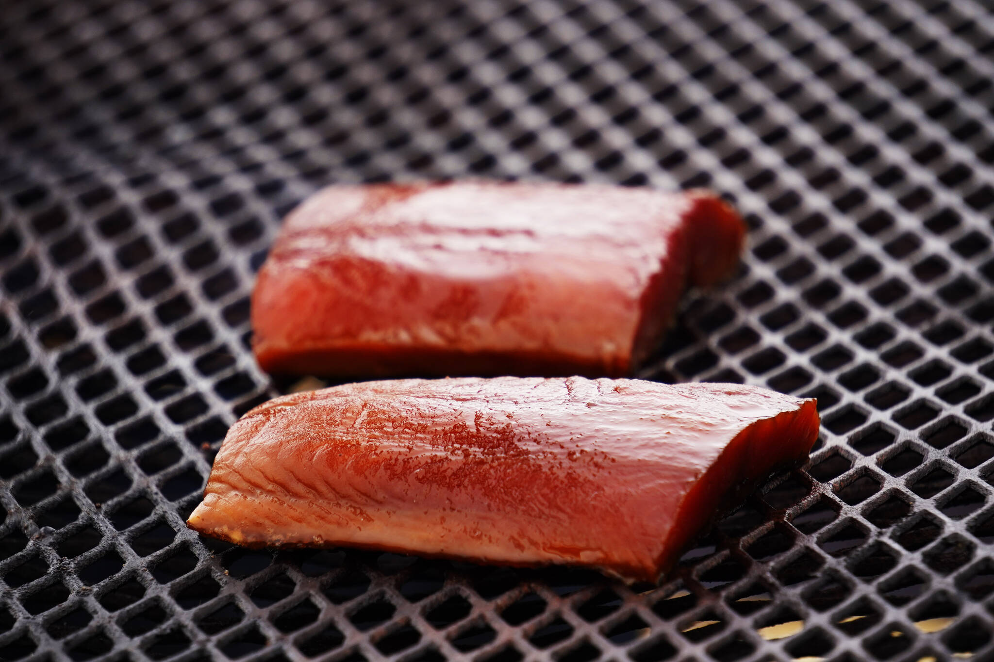 Salmon rests on a grill at Return of the Reds on Saturday, June 3, 2023, at the Kenai City Dock in Kenai, Alaska. (Jake Dye/Peninsula Clarion)