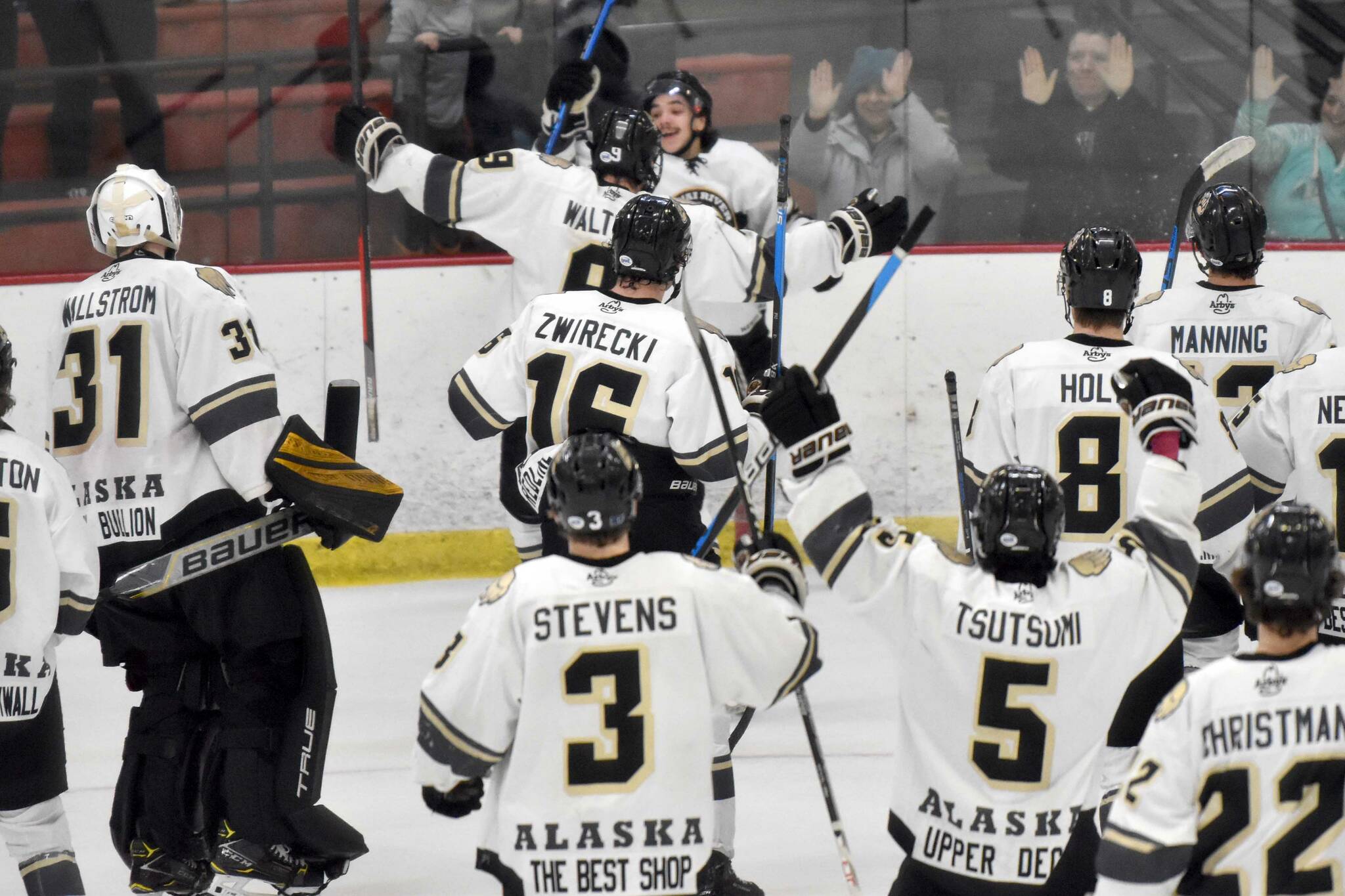 The Kenai River Brown Bears mob Ryan Finch after he scored the game-winning goal in overtime against the Janesville (Wisconsin) Jets on Saturday, Feb. 25, 2023, at the Soldotna Regional Sports Complex in Soldotna, Alaska. (Photo by Jeff Helminiak/Peninsula Clarion)